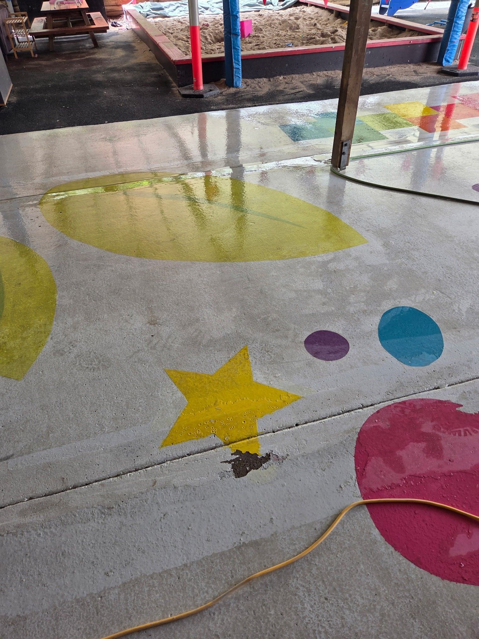Concrete Patio Floor Painted With Colorful Shapes — Priority Painters in Gladstone Central, QLD