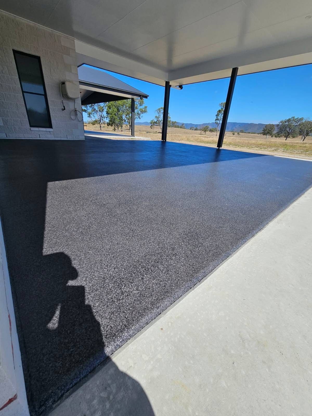 A Covered Outdoor Patio Featuring a Speckled Gray Epoxy Floor — Priority Painters in Gladstone Central, QLD
