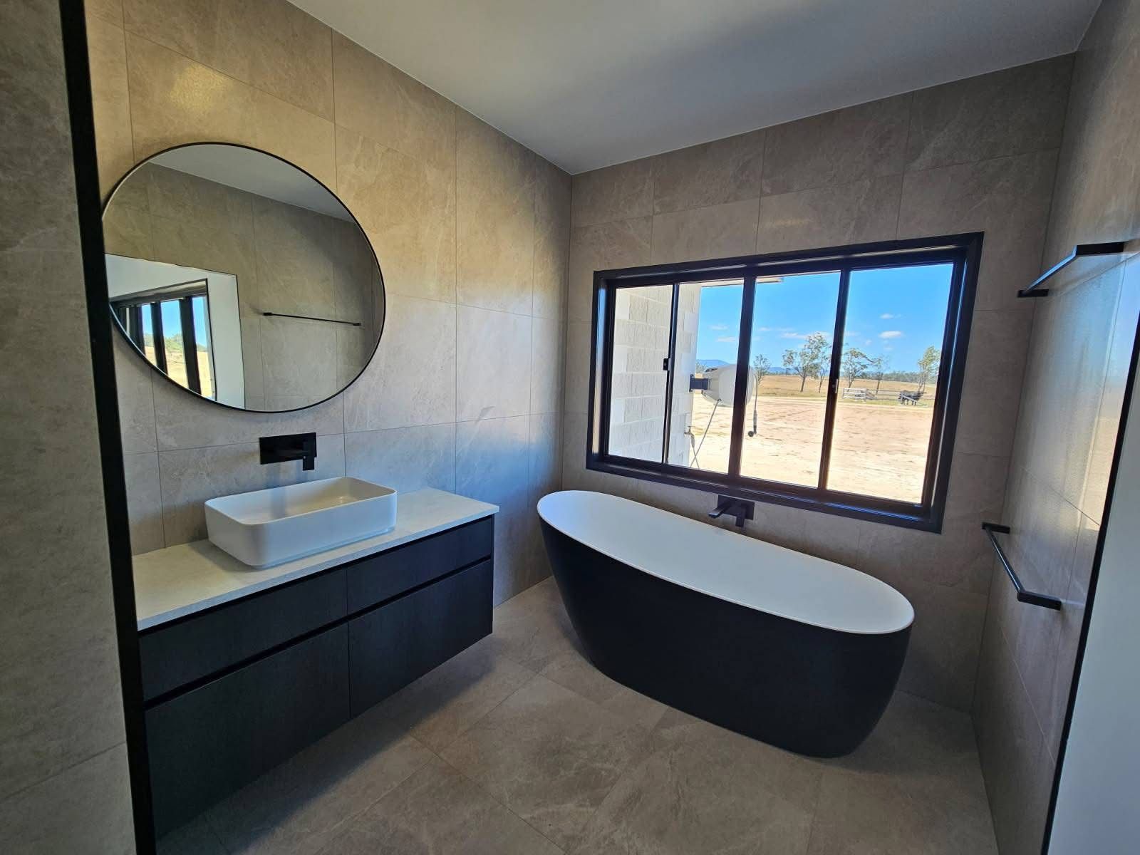 A Modern, Neutral-toned Bathroom Featuring a Black Floating Vanity — Priority Painters in Gladstone Central, QLD