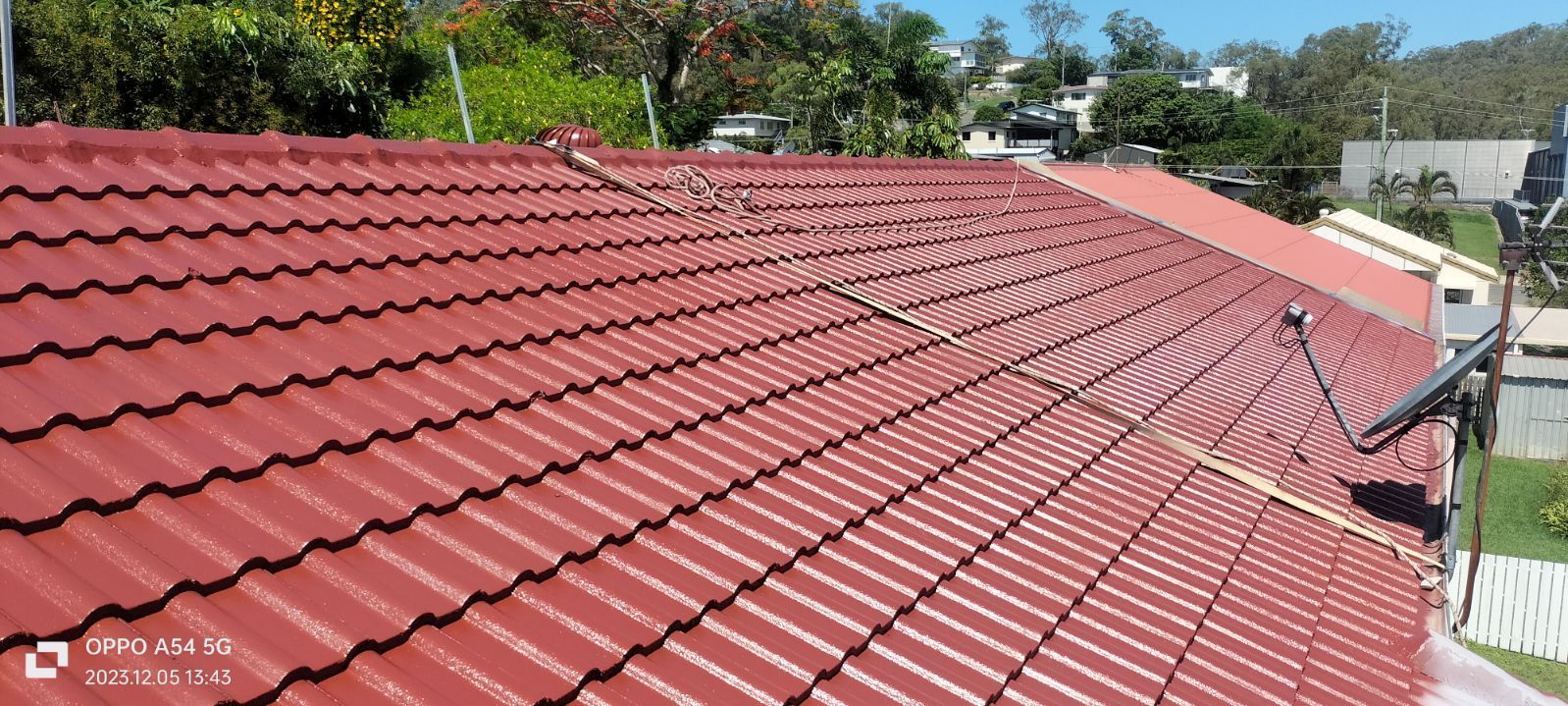 A View of a Reddish-brown Corrugated Metal Roof From Above — Priority Painters in Gladstone Central, QLD
