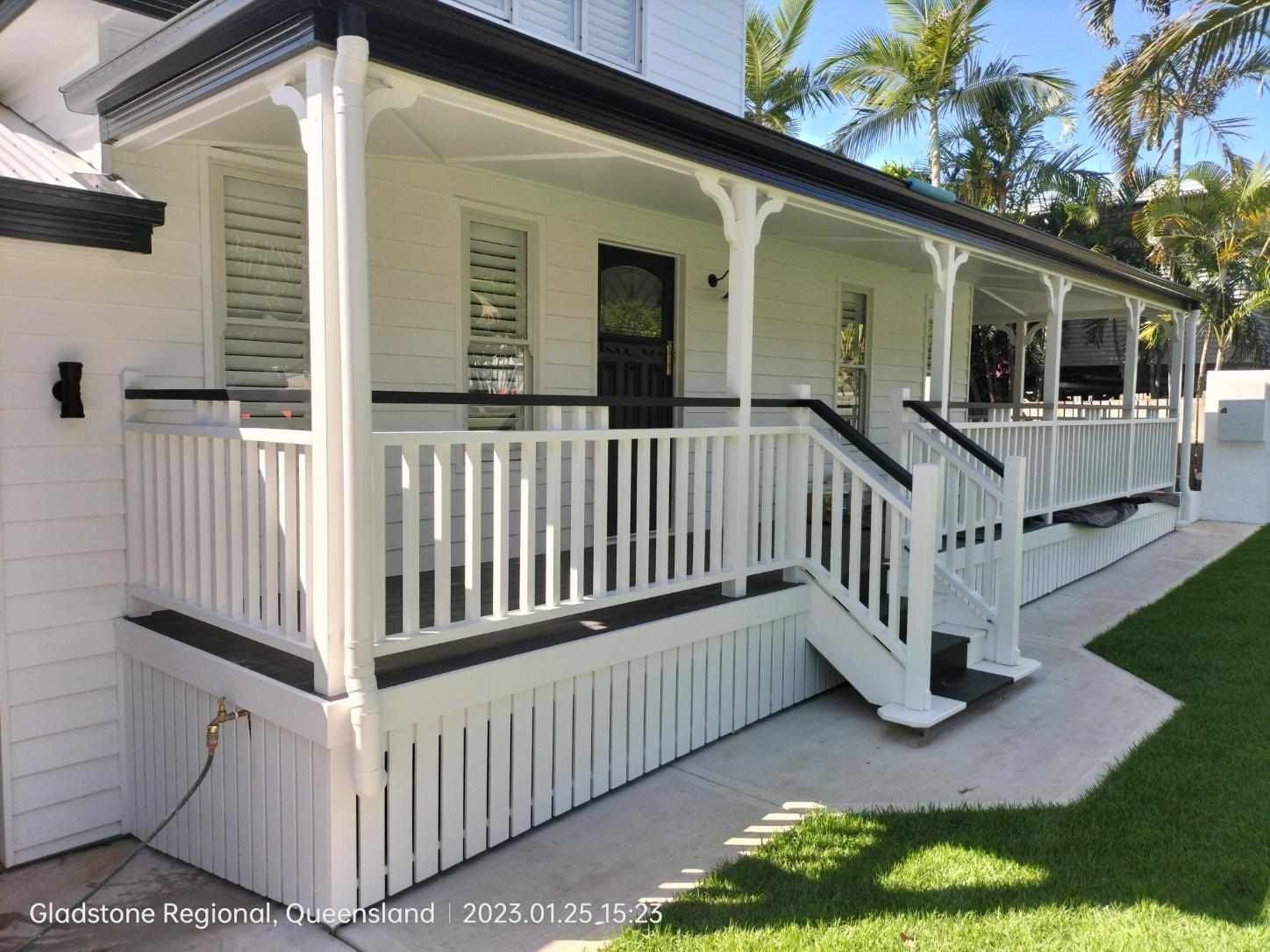 A White House With a Wrap-around Porch, Featuring Dark Railings — Priority Painters in Gladstone Central, QLD