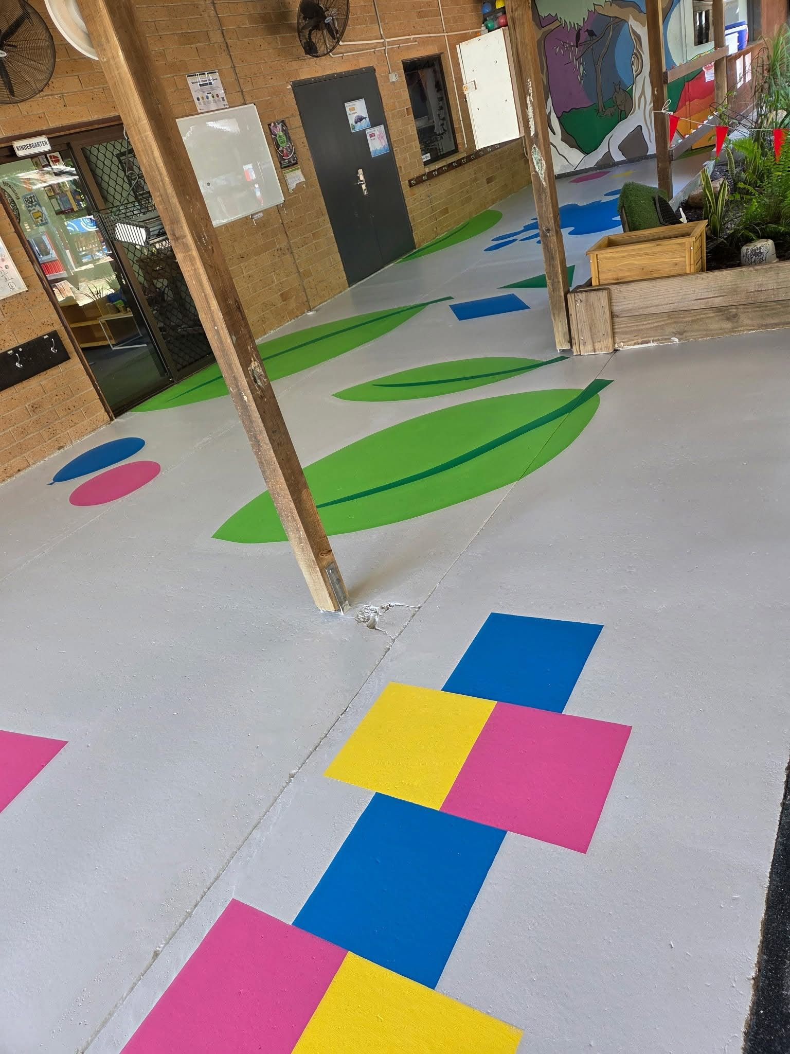 A Light Gray Floor in a Play Area Features Colorful Painted Shapes — Priority Painters in Gladstone Central, QLD