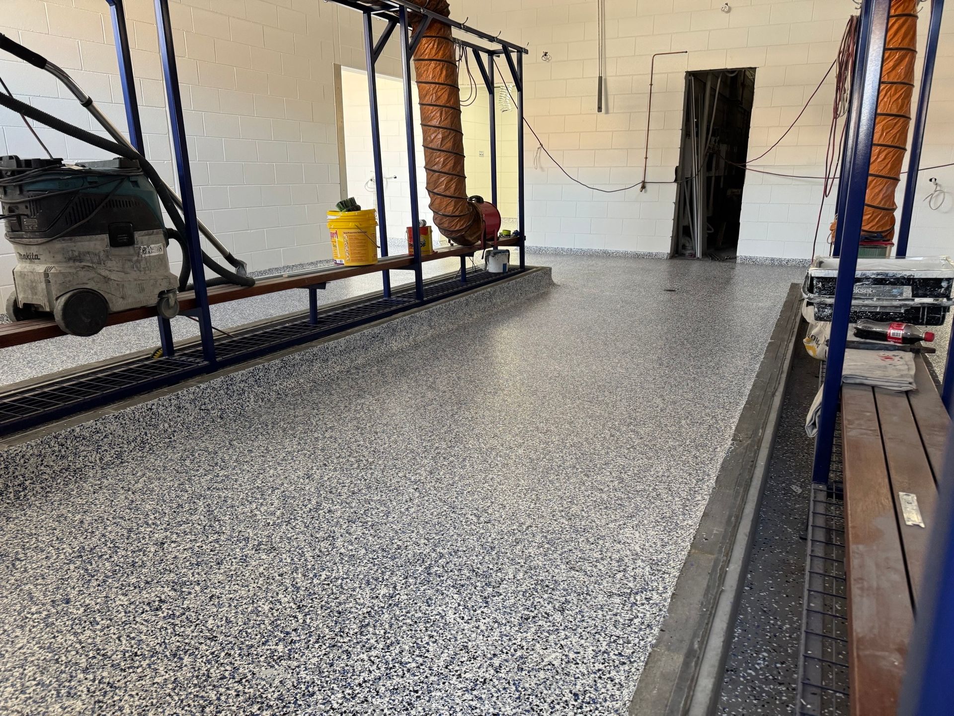 A Locker Room With a Speckled Grey Epoxy Floor — Priority Painters in Gladstone Central, QLD