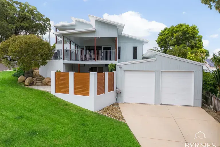A Wooden Balcony, and a Sloping Green Lawn in Front — Priority Painters in Gladstone Central, QLD