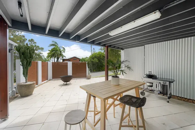 A Covered Outdoor Patio Featuring a  White Tiled Flooring — Priority Painters in Gladstone Central, QLD 