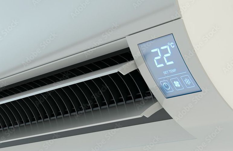 Air conditioner unit with digital display showing 22 degrees Celsius.