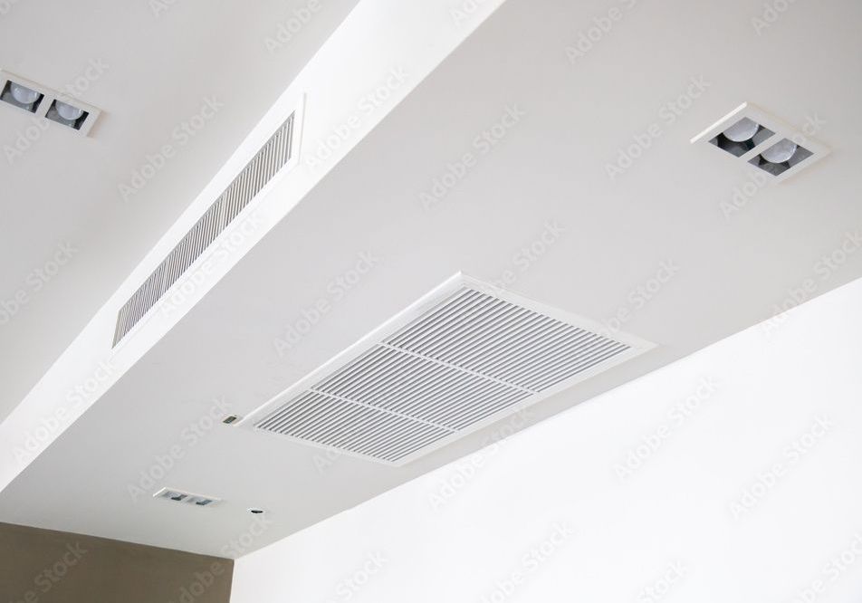 White ceiling with recessed lighting and air vents.