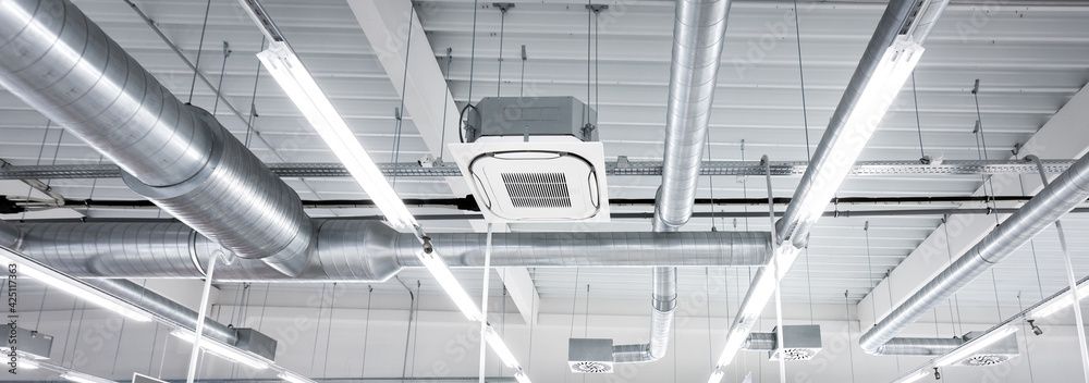 Ceiling with air ducts, lights, and air conditioning unit.