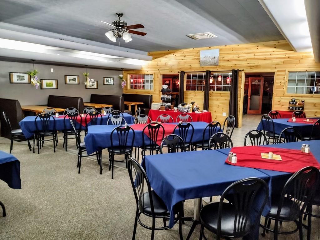 a restaurant with blue tables and black chairs