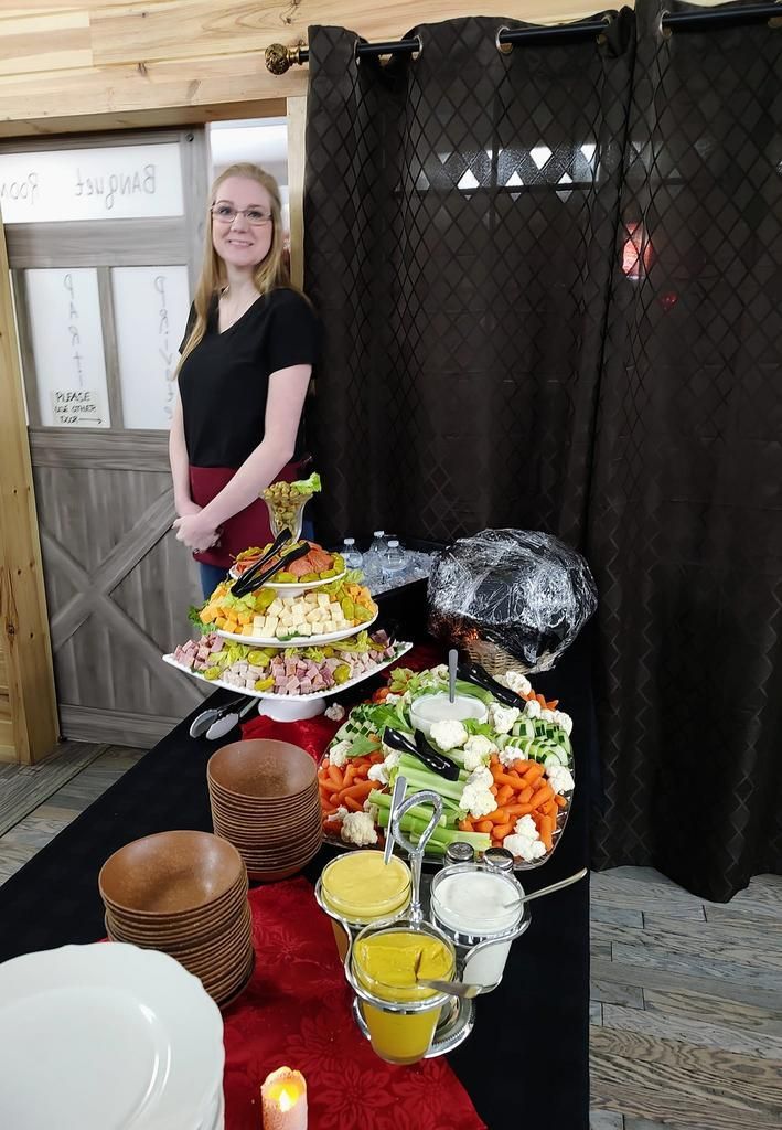 a woman stands in front of a buffet table with a sign that says please do not touch