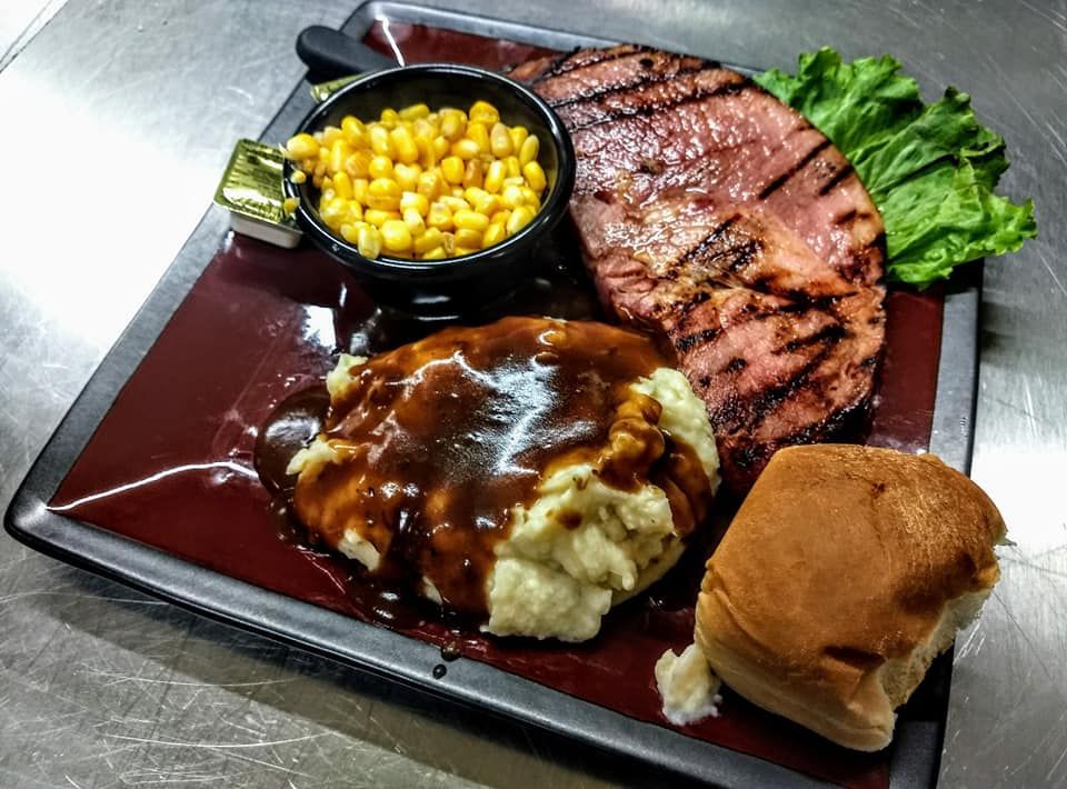 a plate of food with mashed potatoes and corn on the cob