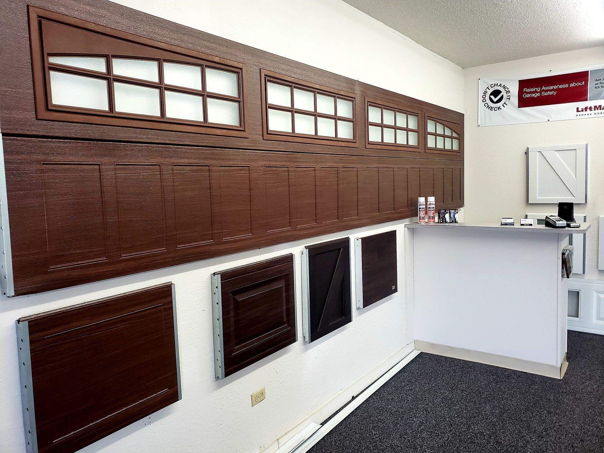 Brown wall of mailboxes and slots in a post office lobby beside a white service counter