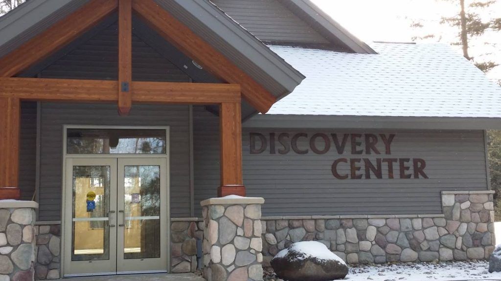 Discovery Center entrance with stone facade, wooden trim, and