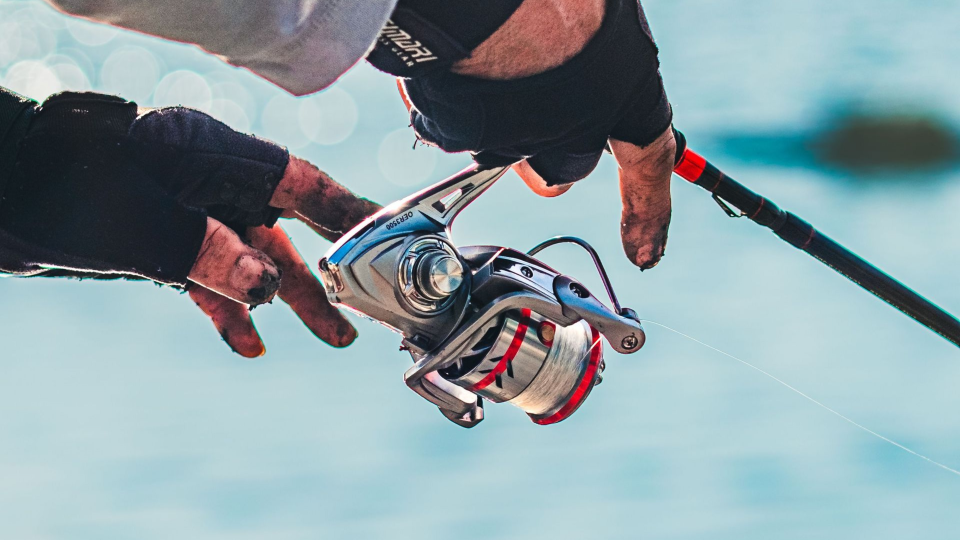 Angler holding a speckled trout over shallow water, with a fishing rod in hand and vest visible