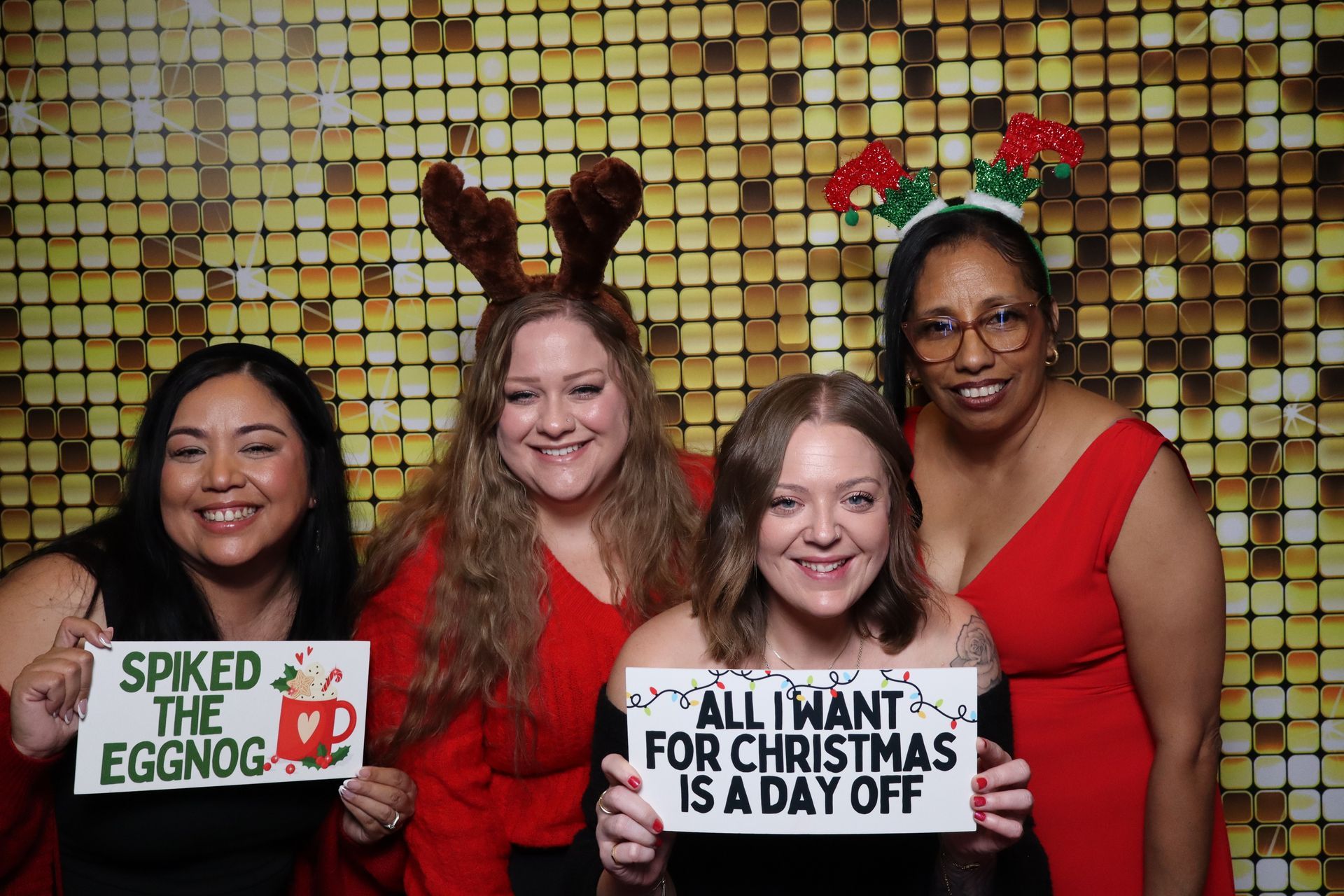 Employees enjoying a holiday party photo booth experience at a corporate event
