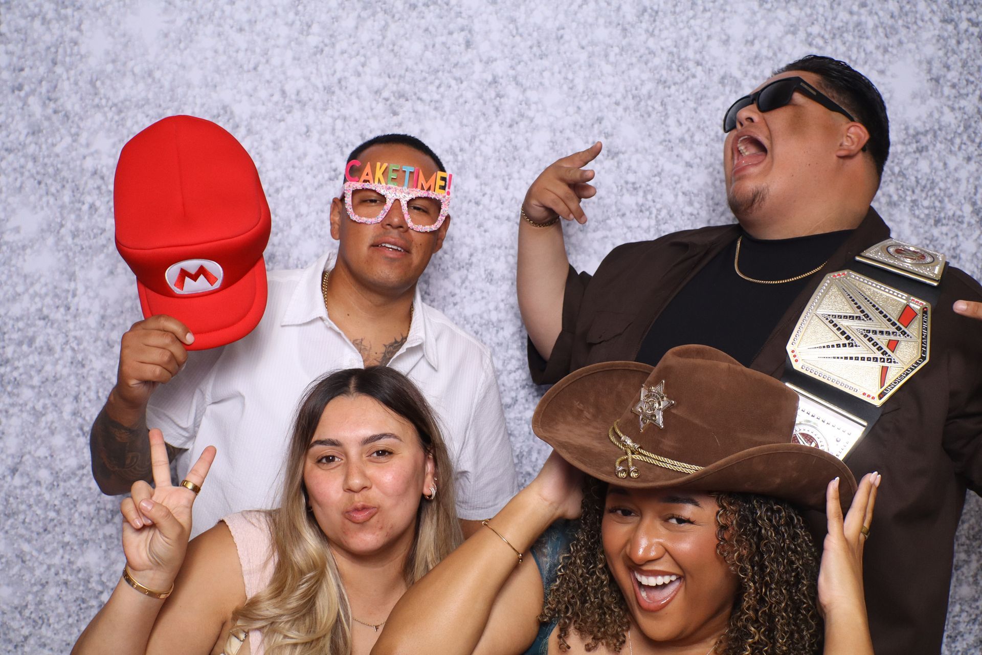 Guests having fun with themed props at Ariel's Quinceañera Photo Booth in Hemet, CA