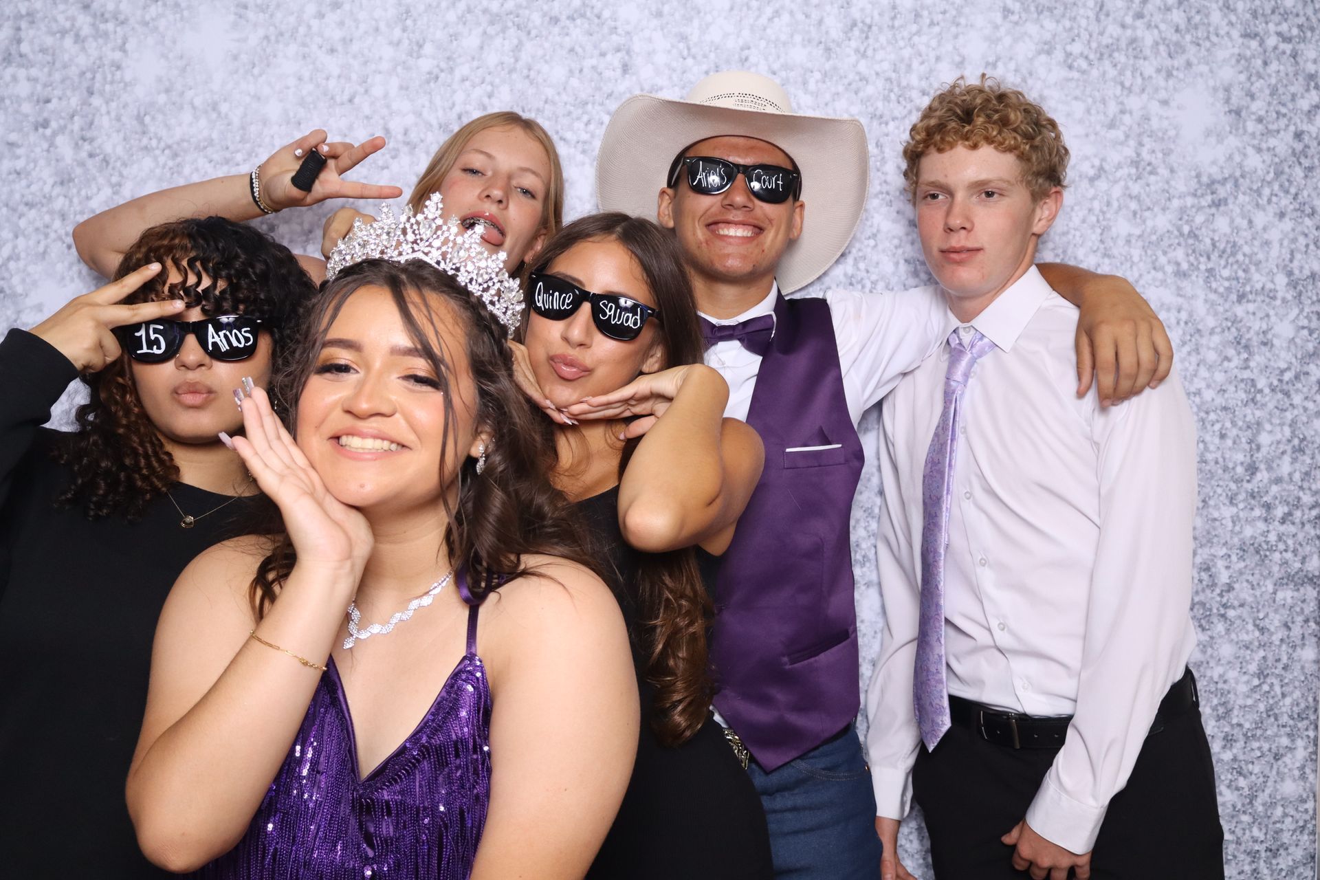 Friends posing with Quinceañera props at Ariel's Quinceañera Photo Booth in Hemet, CA