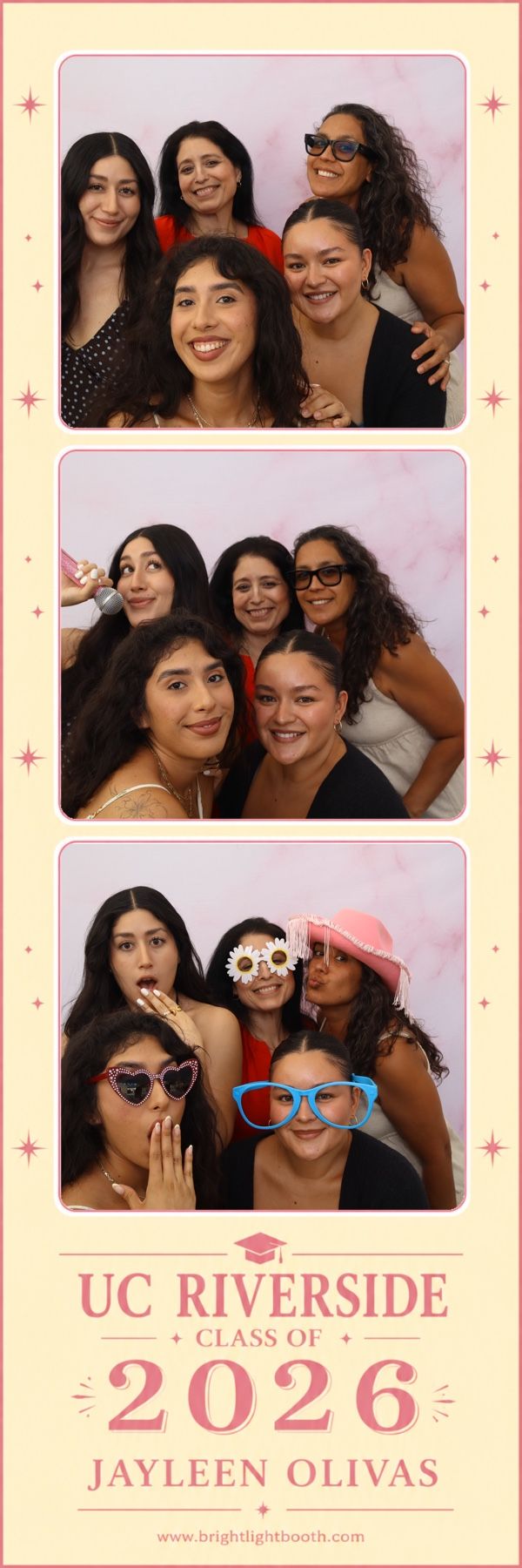 Family and friends posing with fun graduation props in custom photo booth prints at a UC Riverside graduation celebration