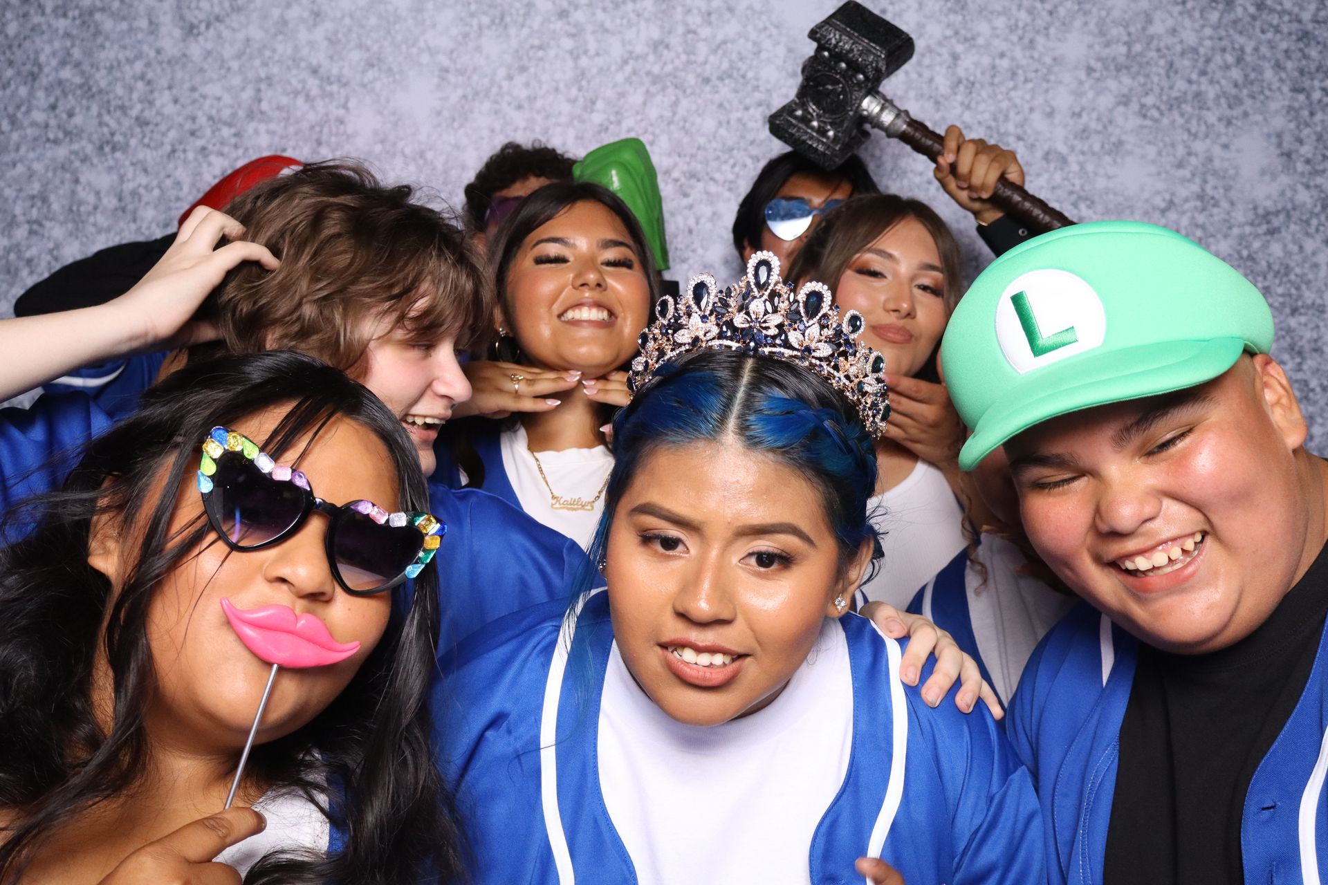 Marleni’s Quinceañera photo booth with friends and fun props in Riverside