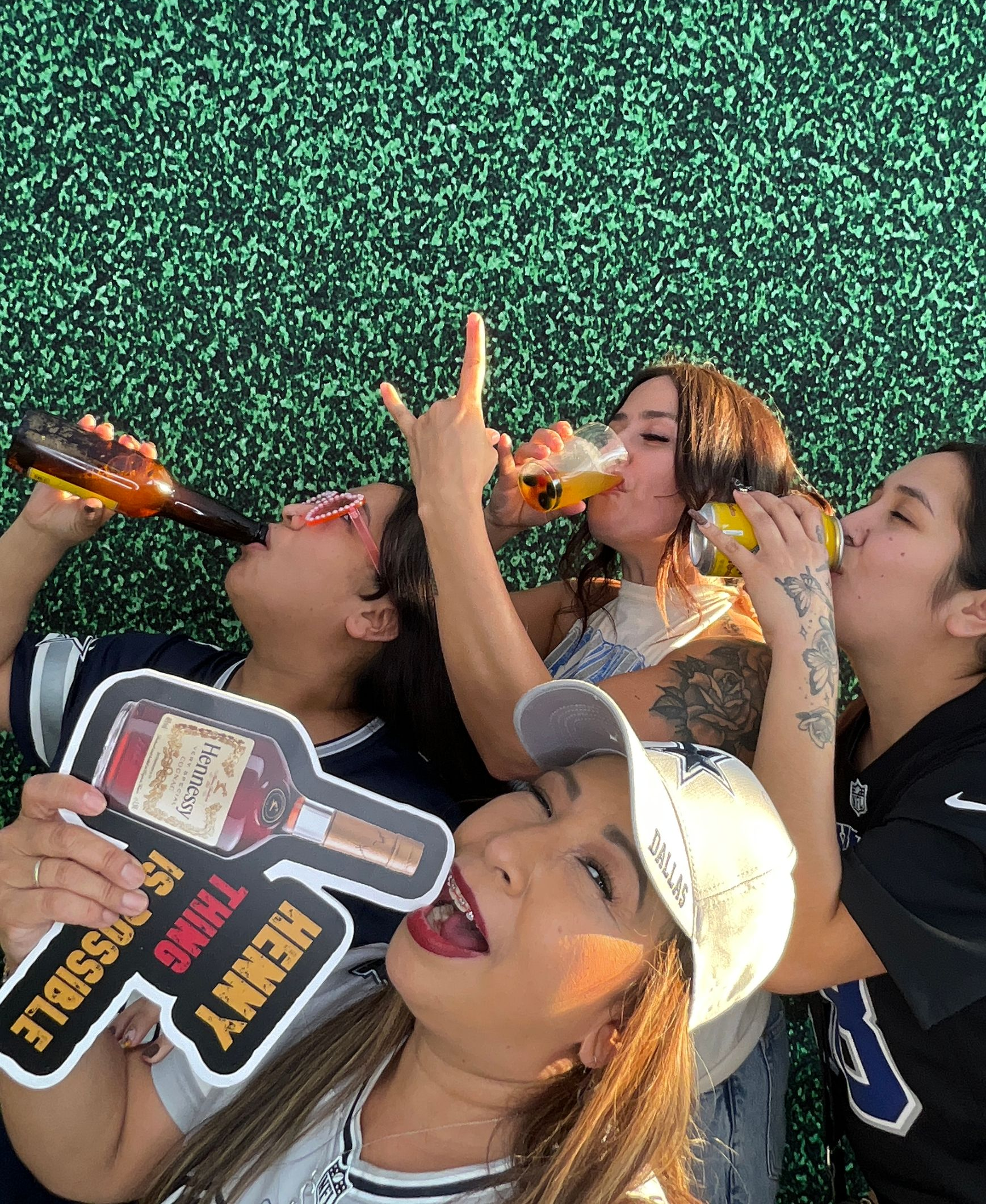 Guests having fun at a sports-themed family reunion photo booth in Riverside, CA