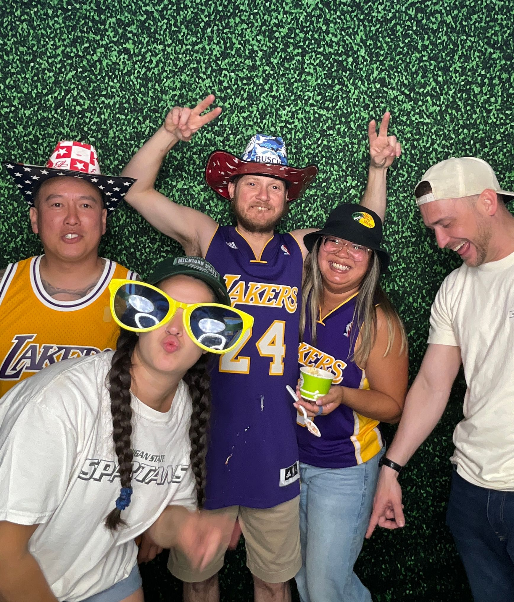 Guests enjoying a sports-themed photo booth at a family reunion in Riverside, CA