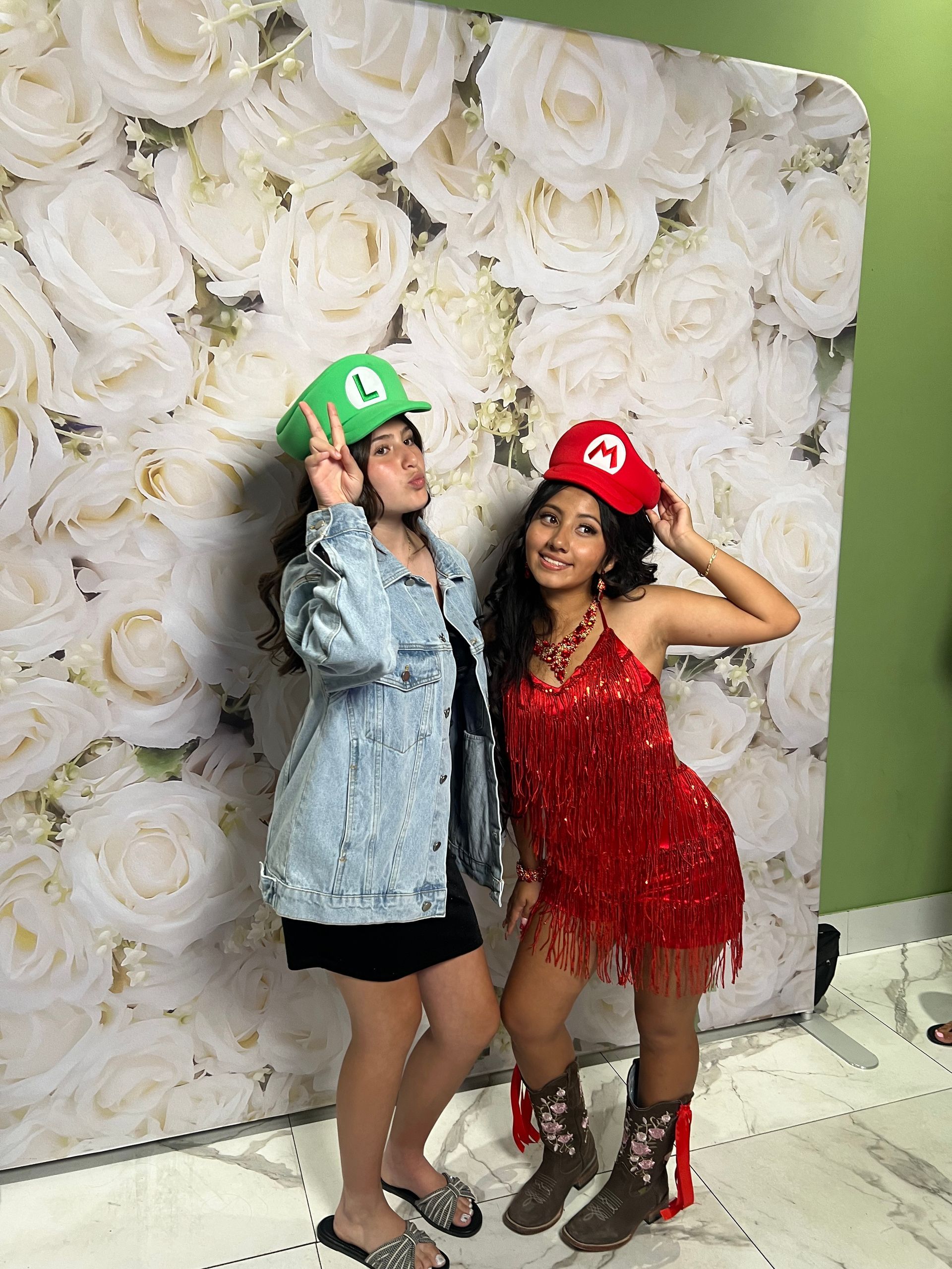 Guests posing with Mario hats at a luxury Quinceañera photo booth at London Garden in Moreno Valley, CA