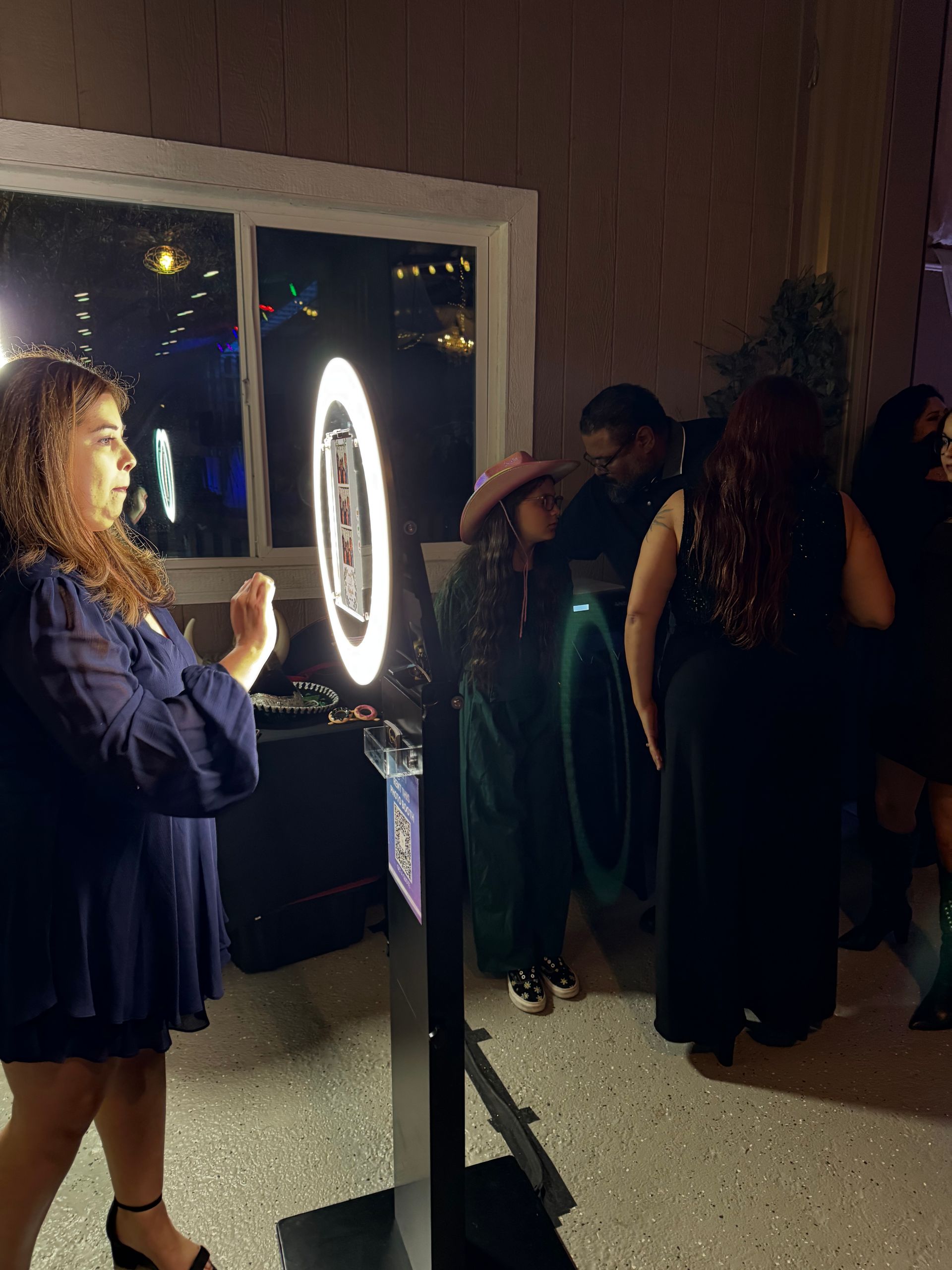 Wedding guests gathered around the Brightlight Photo Booth at Rancho Las Palmas in Perris, CA