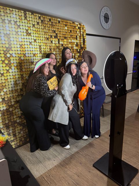 Self-service digital photo booth with premium backdrop at a birthday party