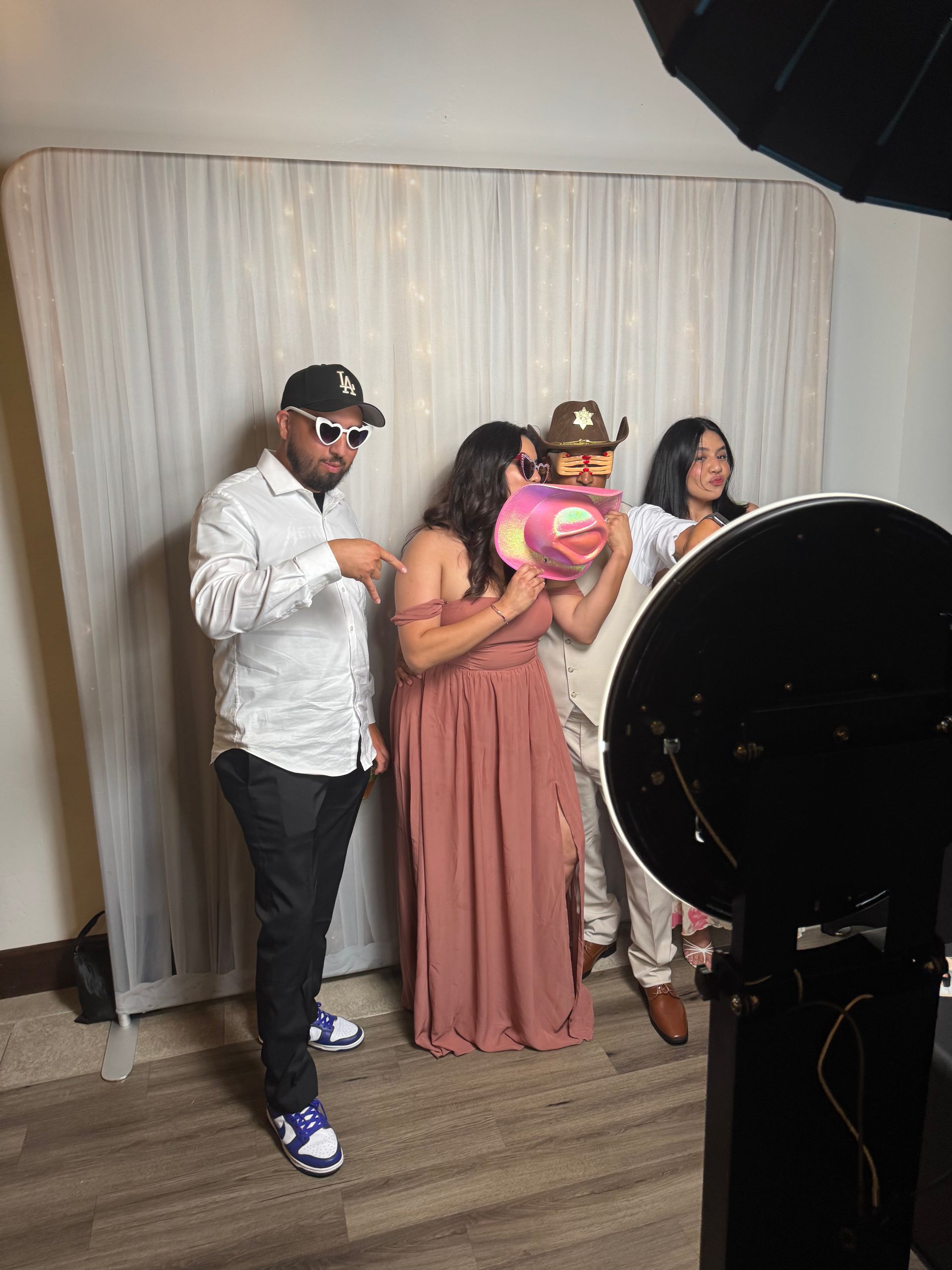 Guests enjoying Rogelio and Roxana's wedding photo booth at Wedgewood Weddings Fallbrook