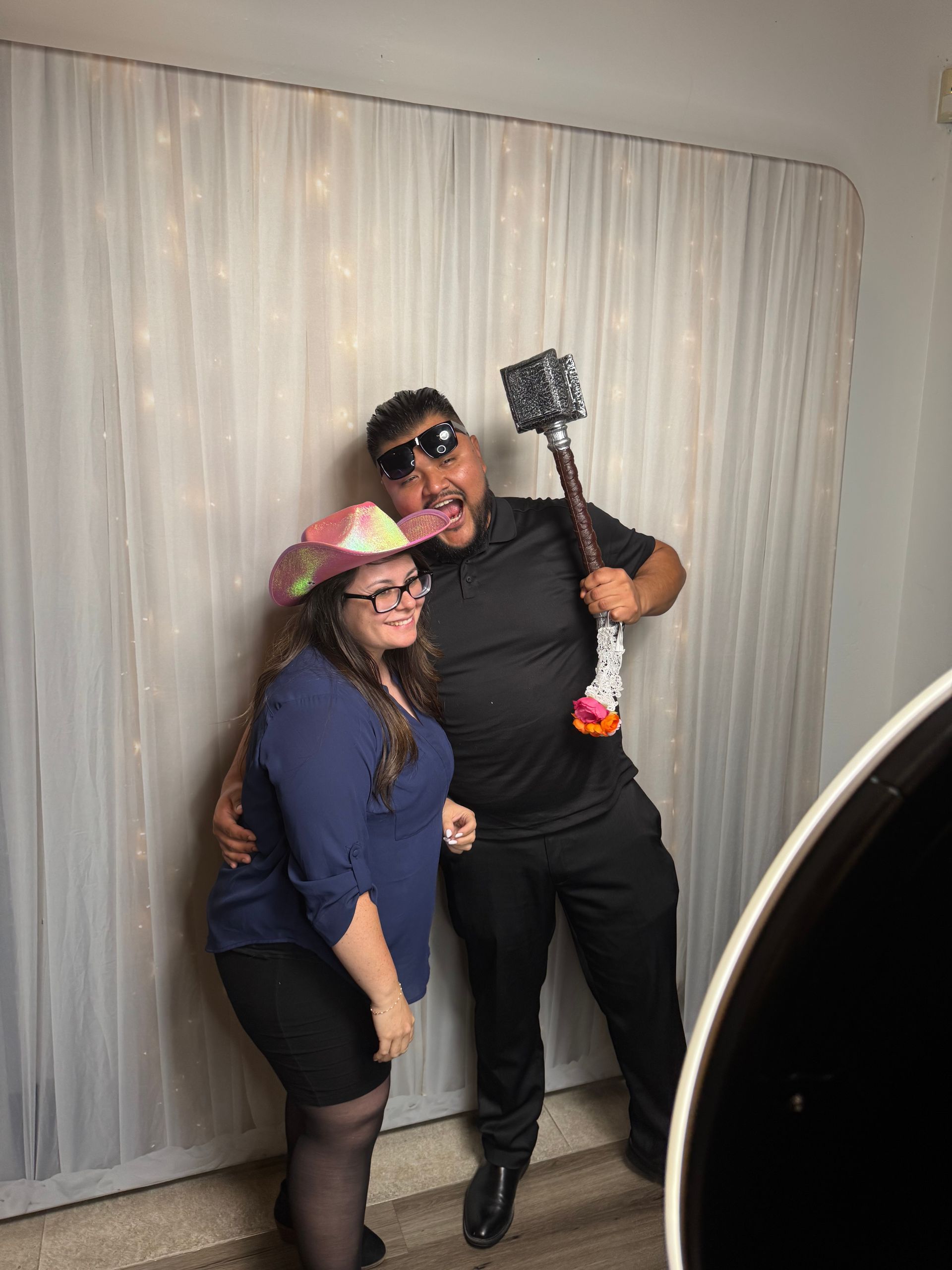 Wedding guests enjoying photo booth props in Fallbrook, CA