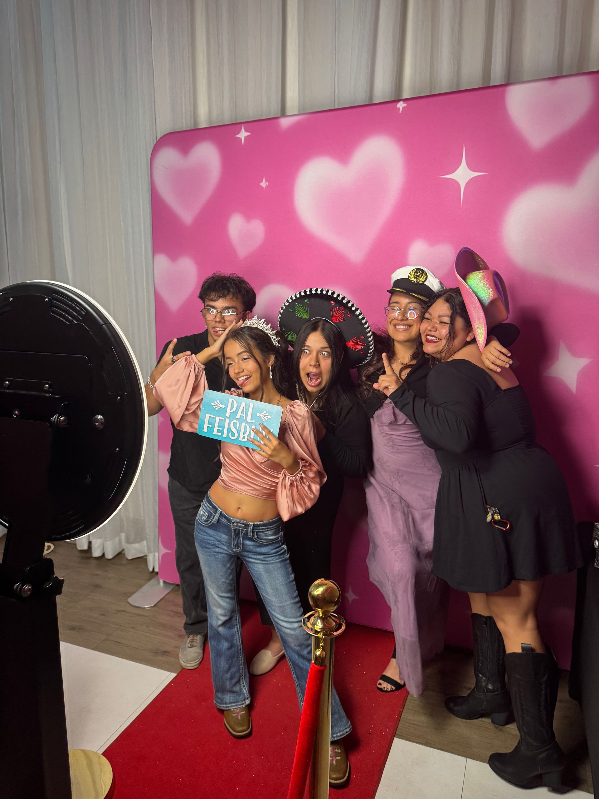 Quinceañera guests enjoying Brightlight's Signature Digital Photo Booth with fun props