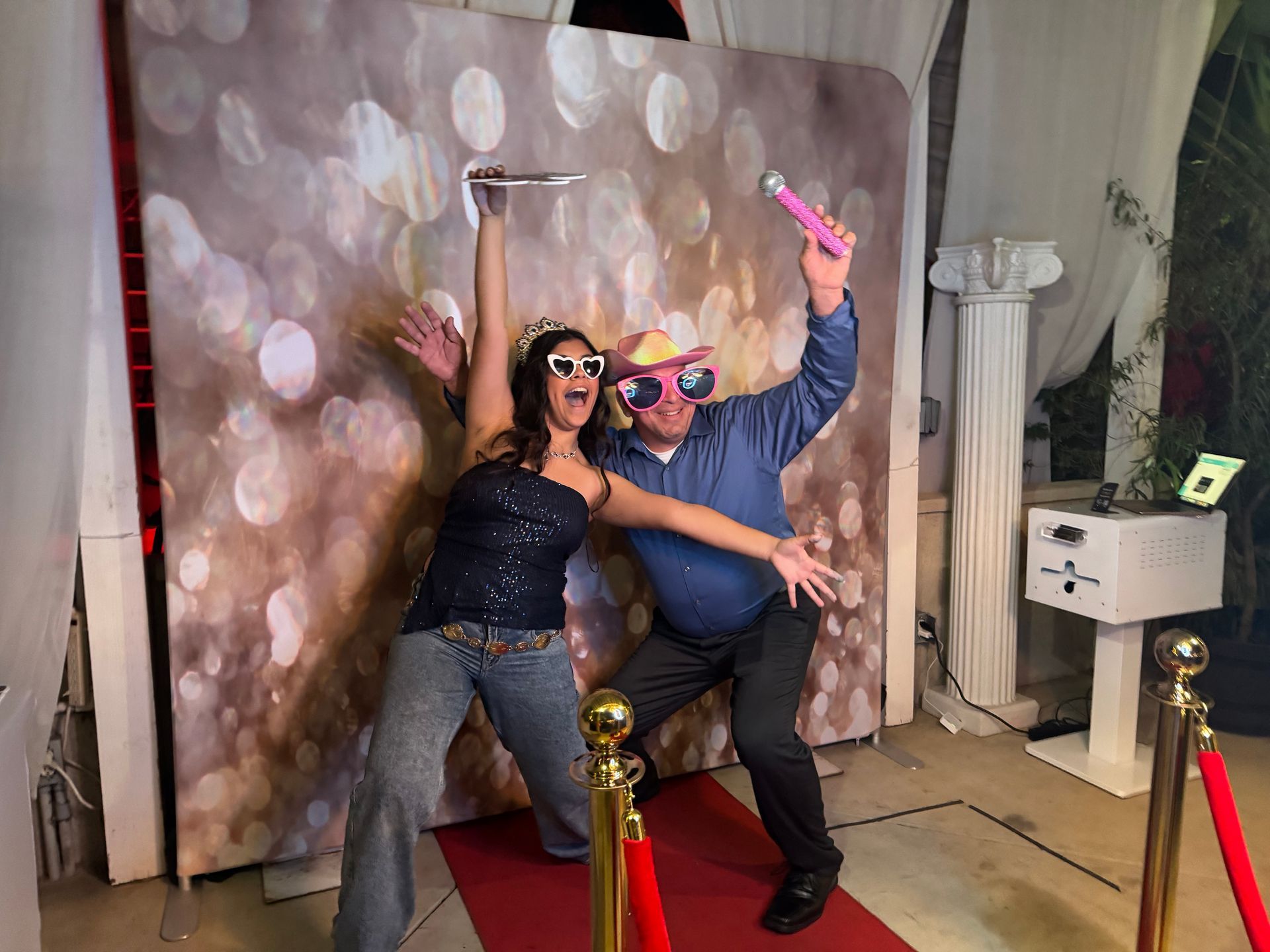 Guests enjoying the Brightlight Photo Booth with a red carpet and Champagne Sparkle backdrop at a quinceañera in Perris, California