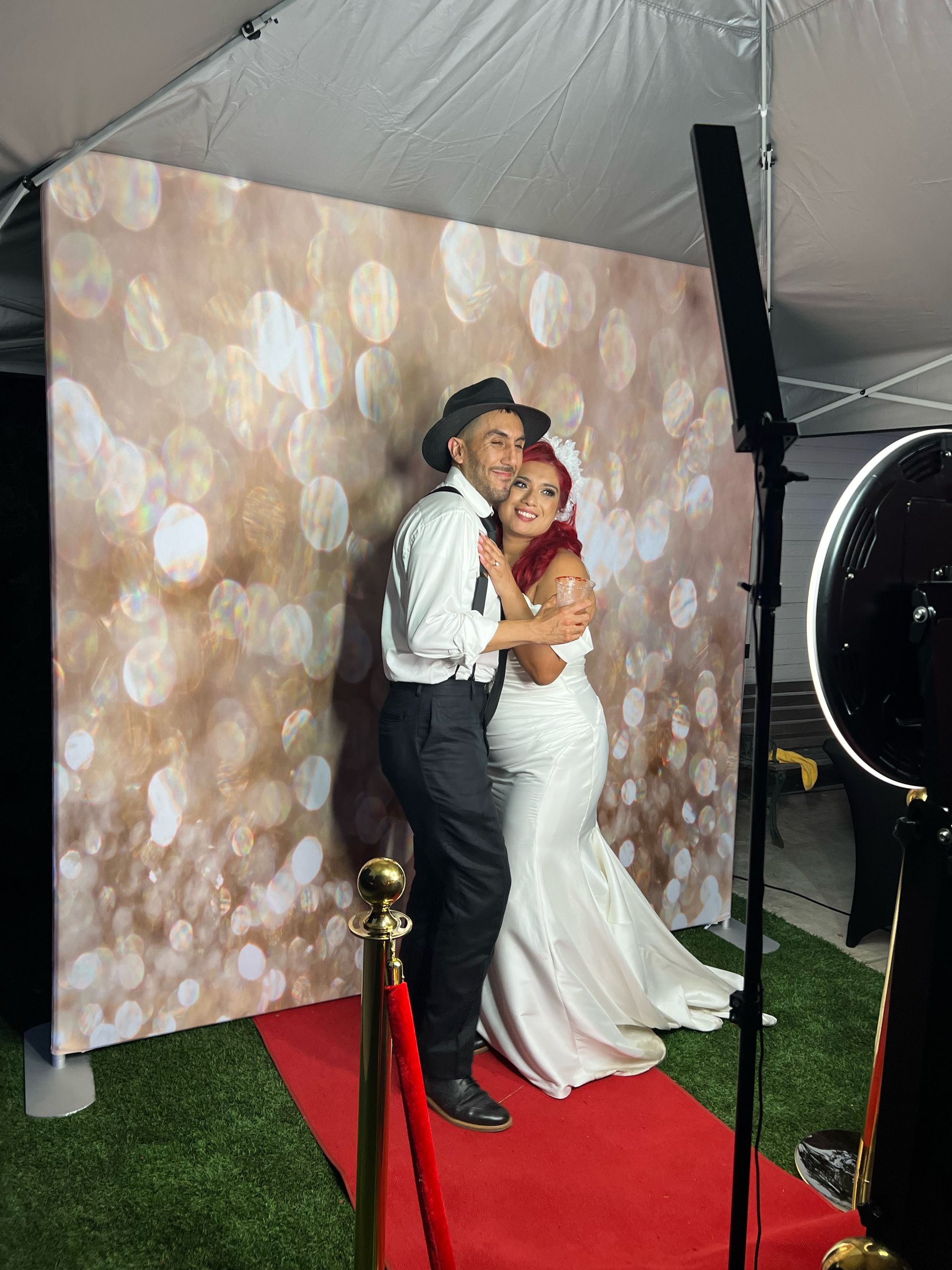 Bride and groom posing at Brightlight Photo Booth during their wedding reception