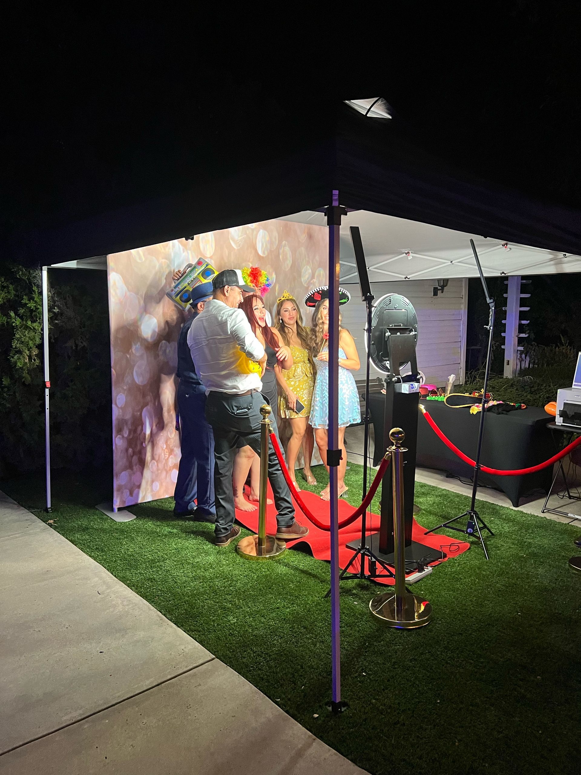 Outdoor wedding photo booth with red carpet at Thatcher Manor Weddings in Gavilan Hills, California