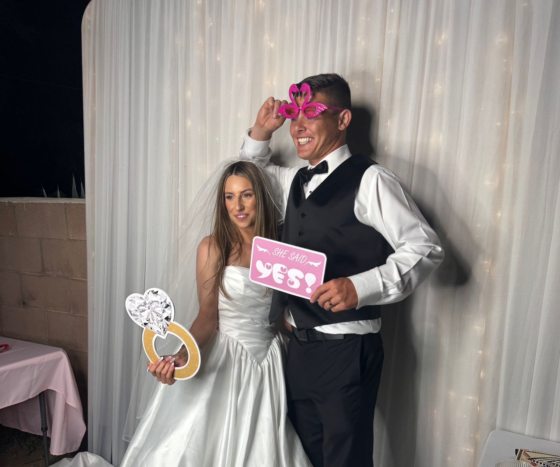 Bride and groom enjoying a luxury wedding photo booth at an estate wedding in Perris, California