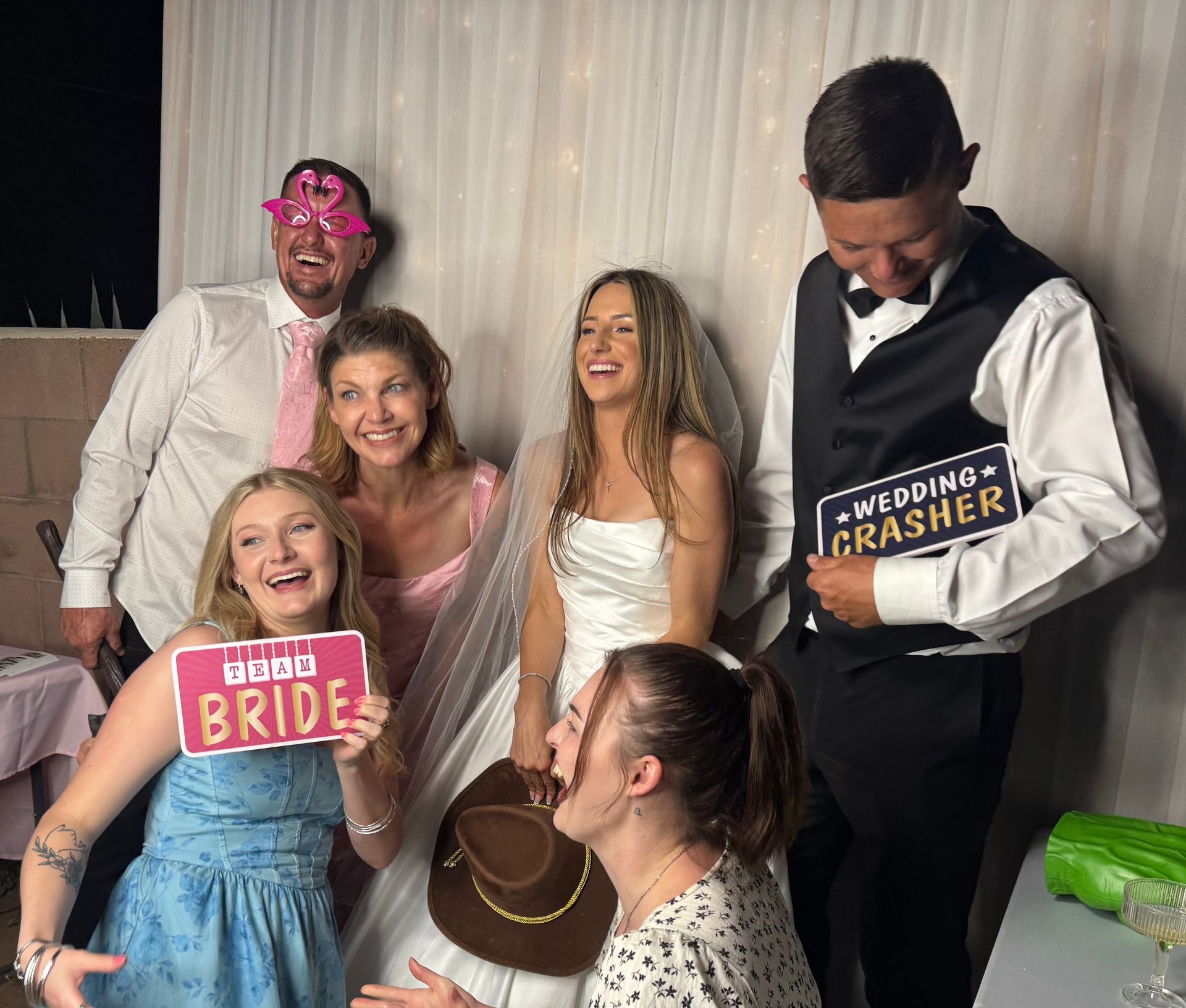 Wedding guests having fun with photo booth props at an estate wedding in Perris, CA