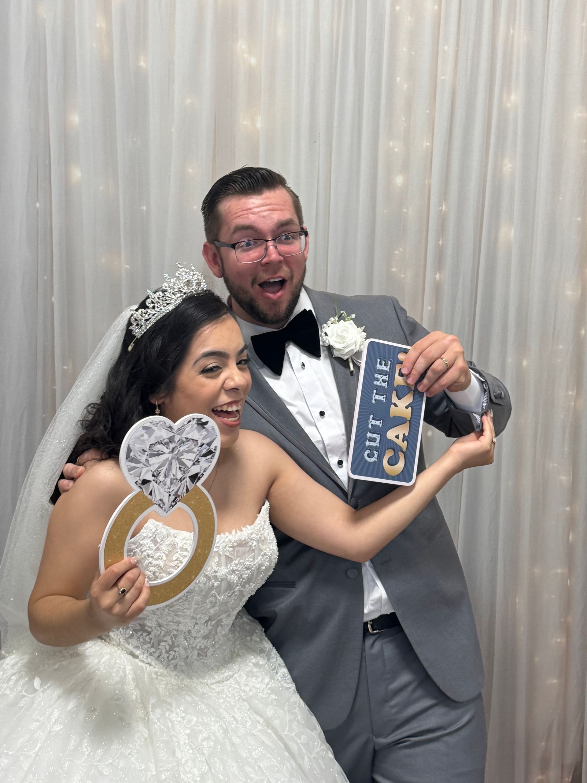 Bride and groom posing with wedding props at Brightlight Photo Booth during their wedding at Towngate Community Center in Moreno Valley, CA