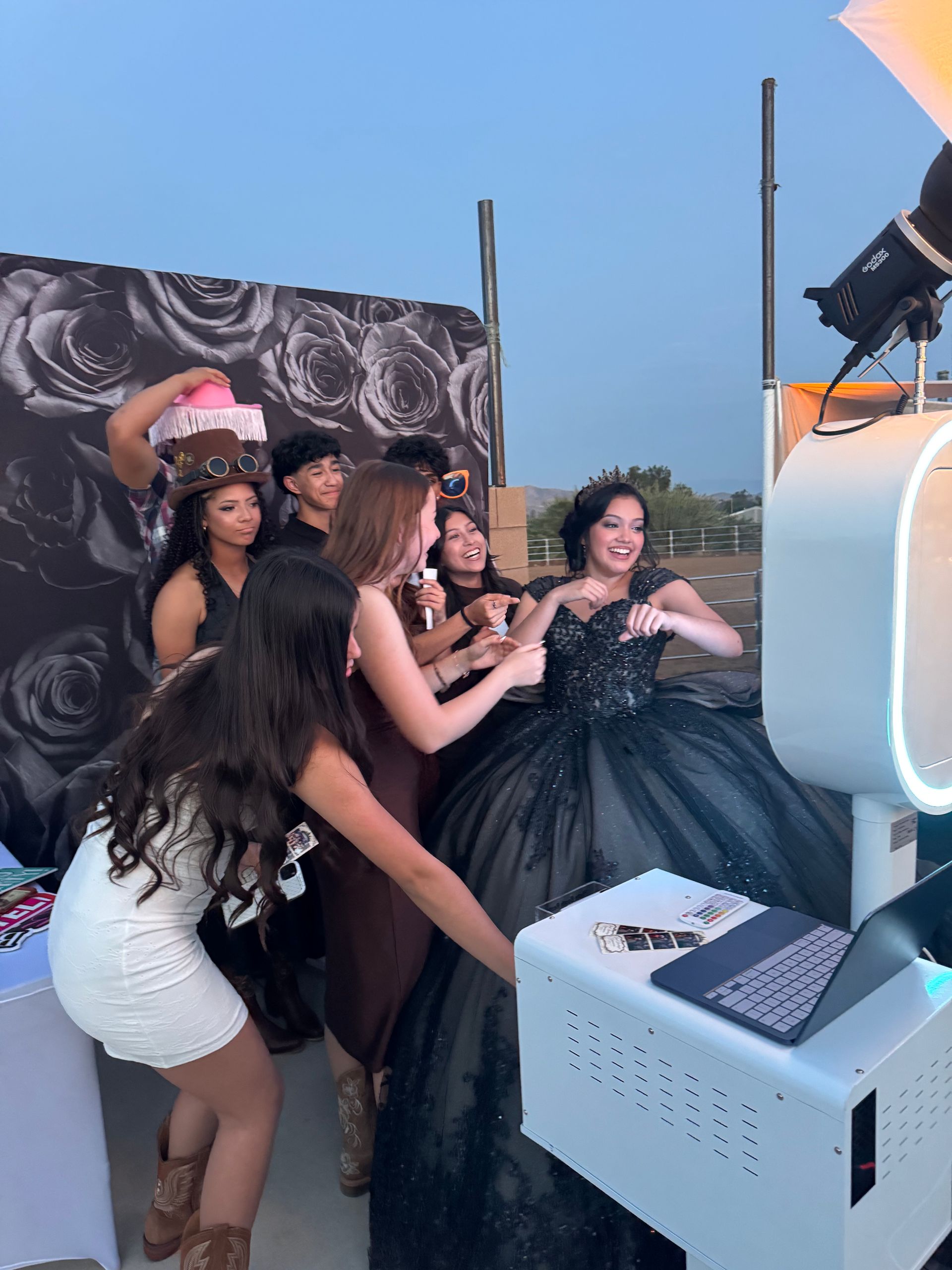 Quinceañera guests posing at a luxury photo booth