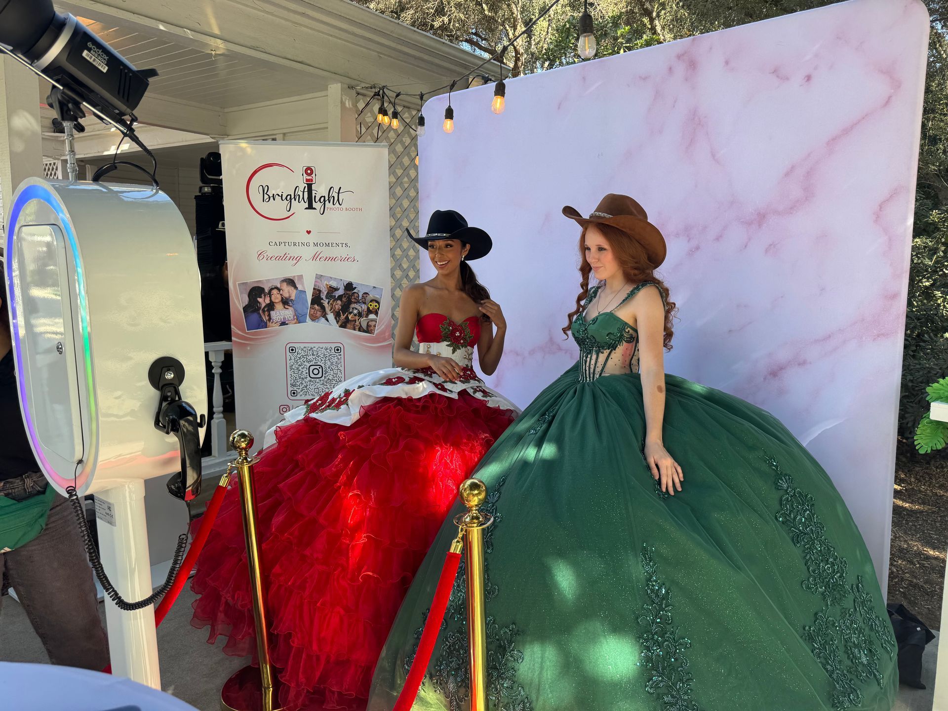 Quinceañera photo booth setup with elegant backdrop and red carpet