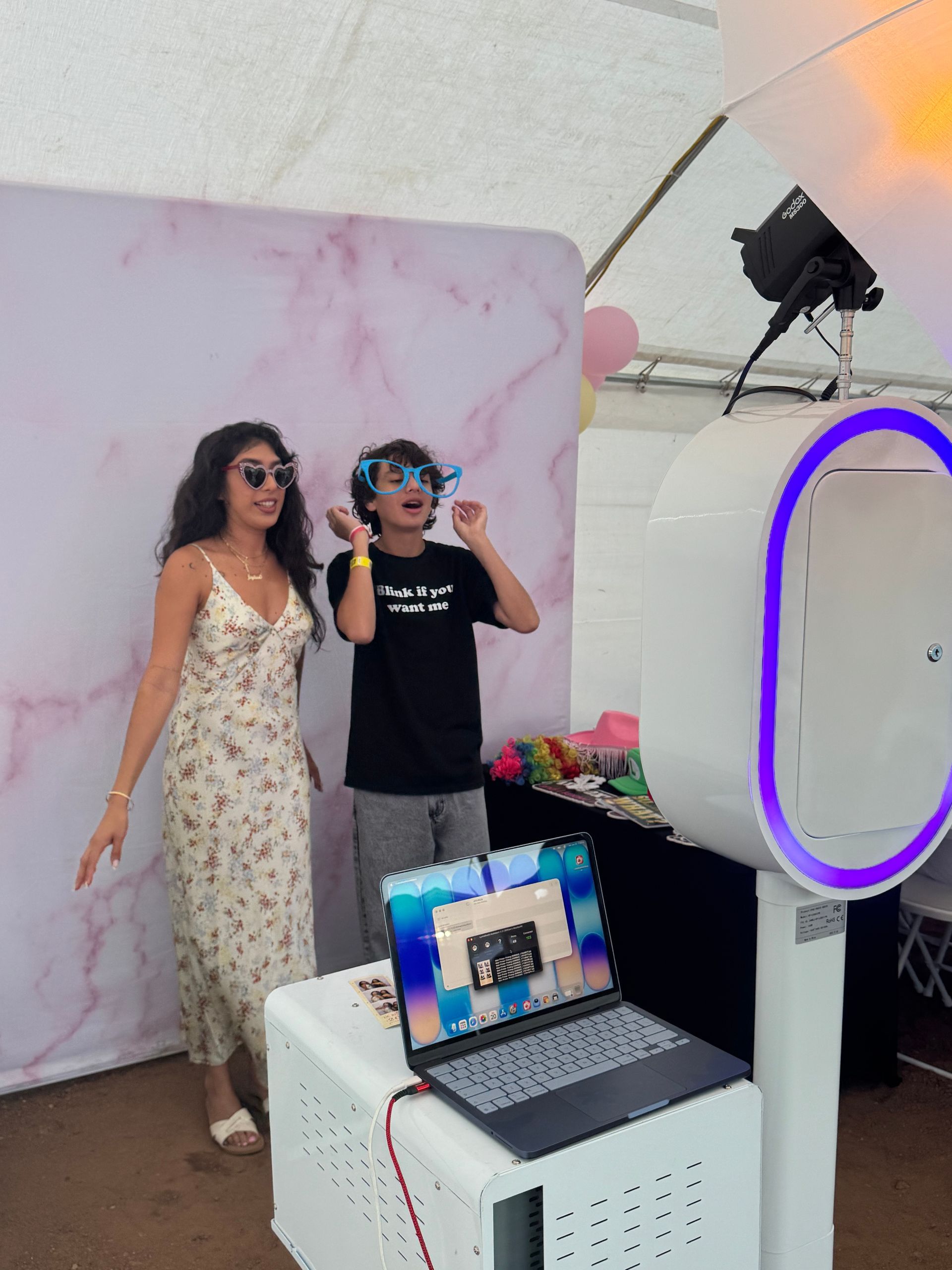 Guests enjoying Brightlight Photo Booth's luxury DSLR photo booth with a pink stone backdrop at a UC Riverside graduation party in Jurupa Valley, CA