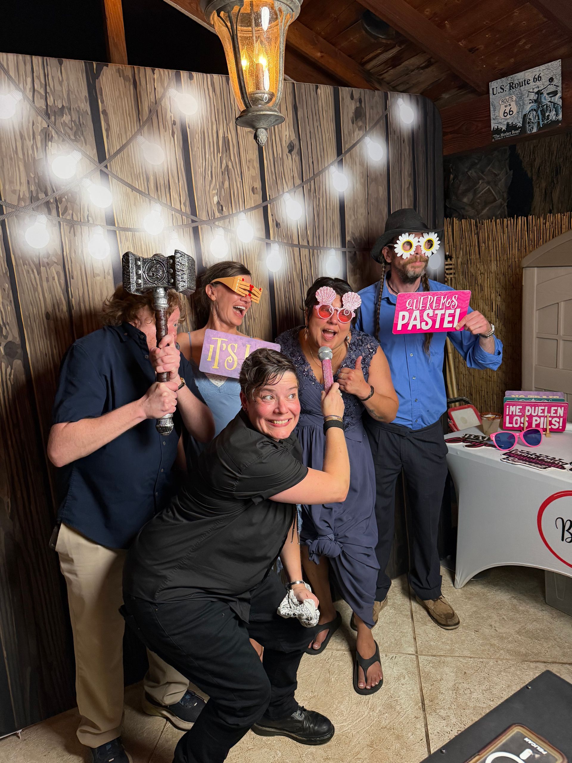 Guests posing with fun photo booth props at Lizzie’s Quinceañera in Riverside, CA