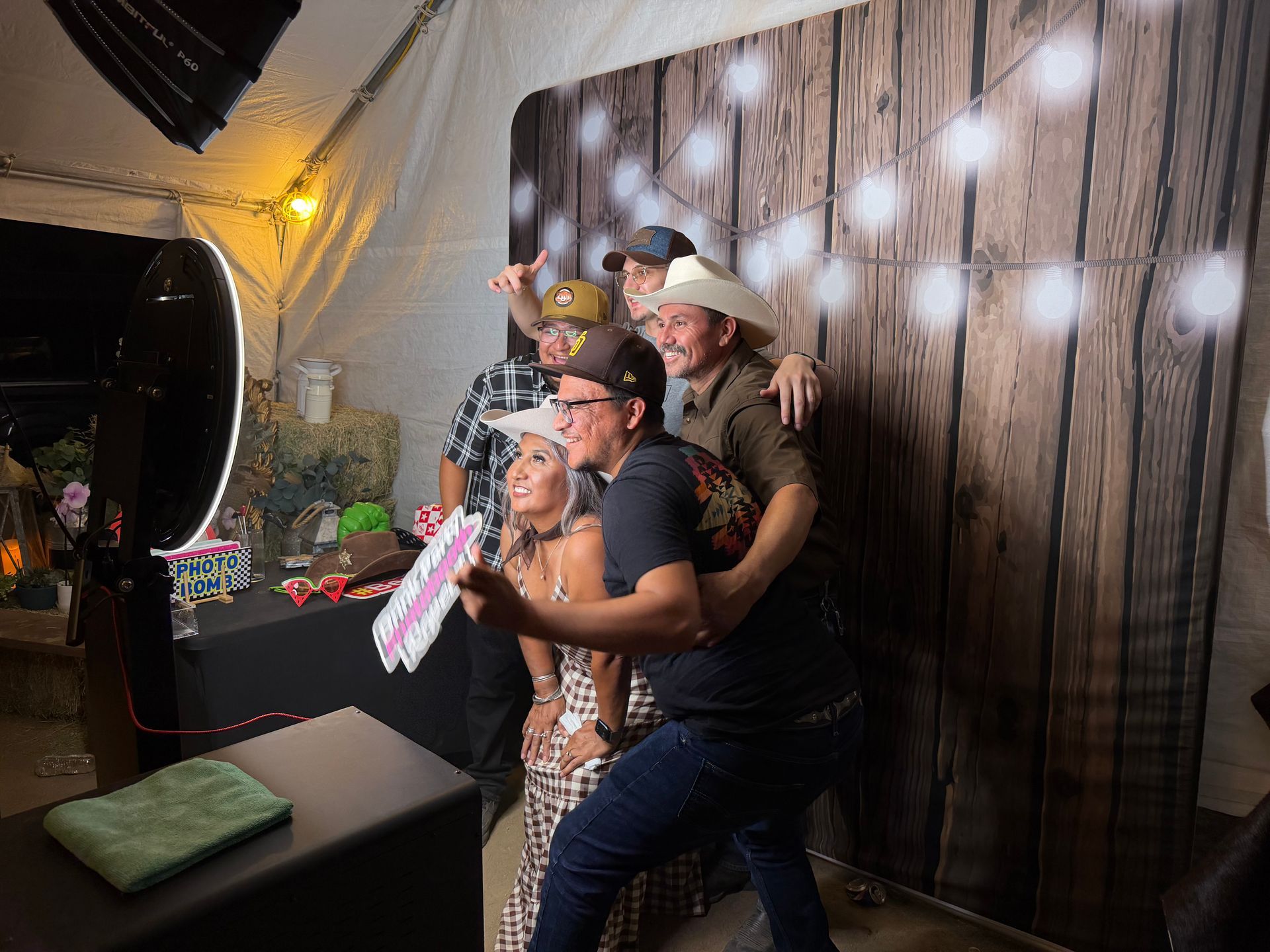 Guests enjoying Dalila’s 56th birthday photo booth with western props and backdrop in Perris, CA