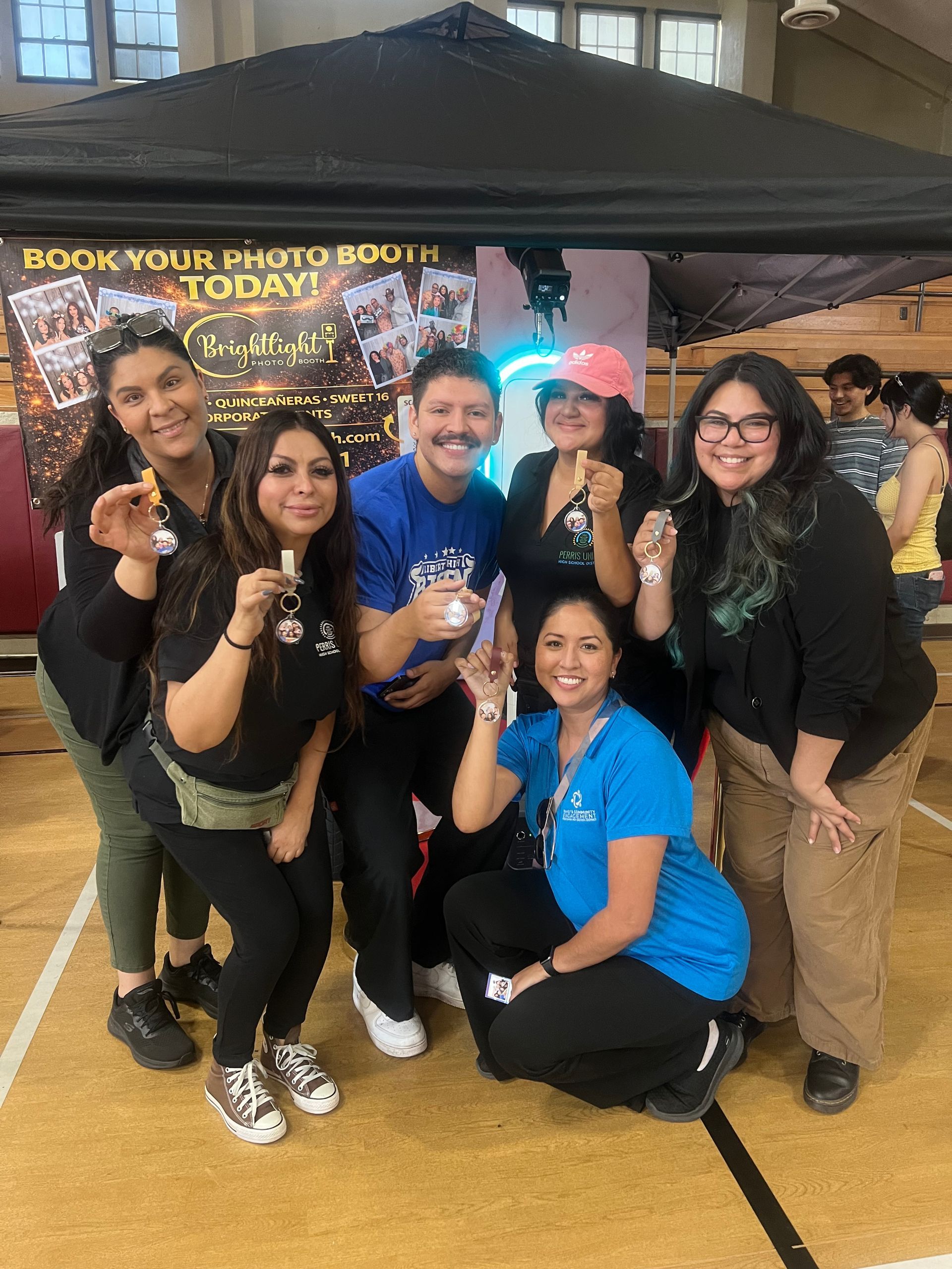 City of Perris Health Fair guests showing their photo booth keychain keepsakes