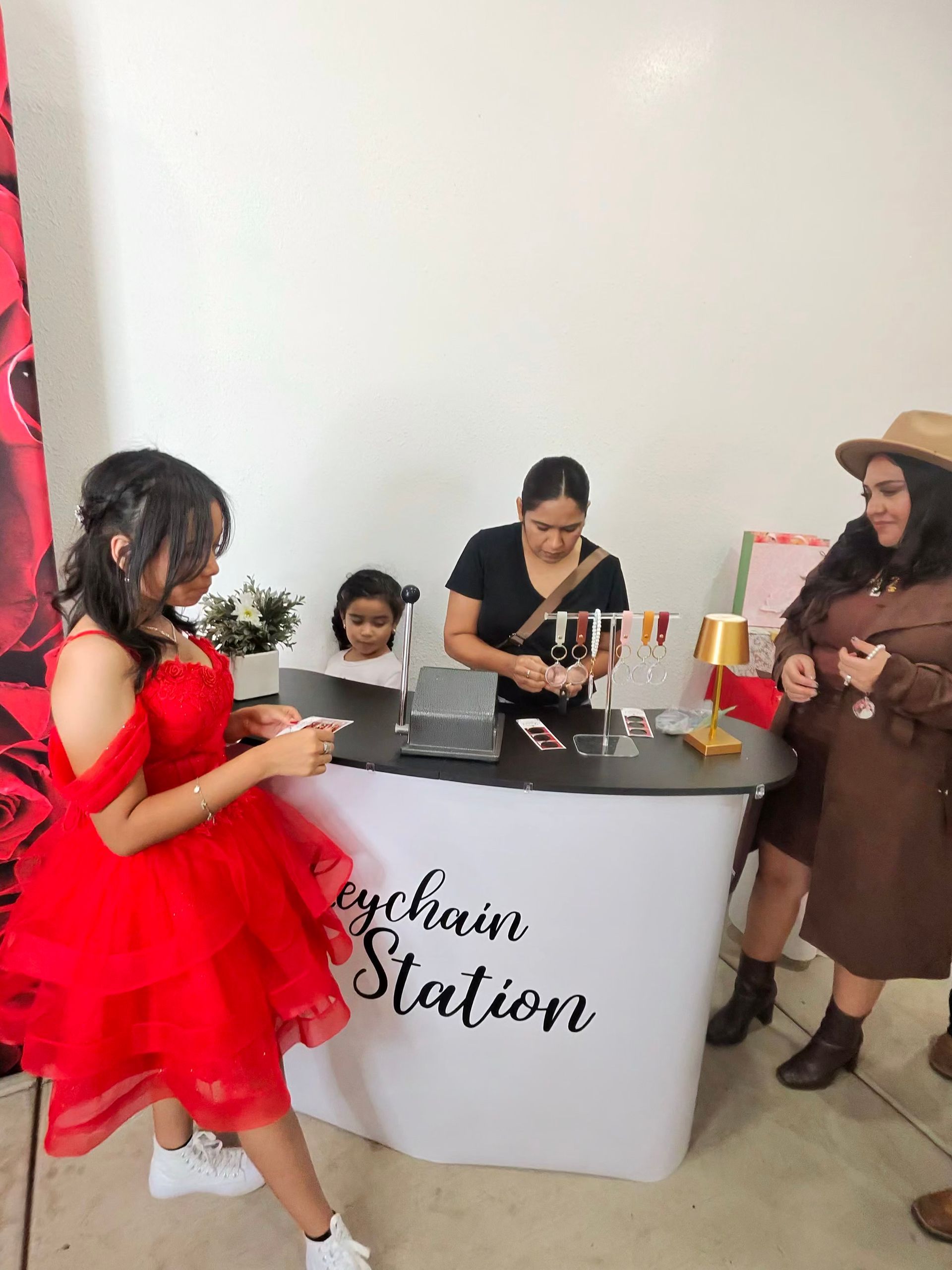 Guests enjoying the Keychain Keepsake Experience at Ivana’s Quinceañera photo booth in Perris, CA