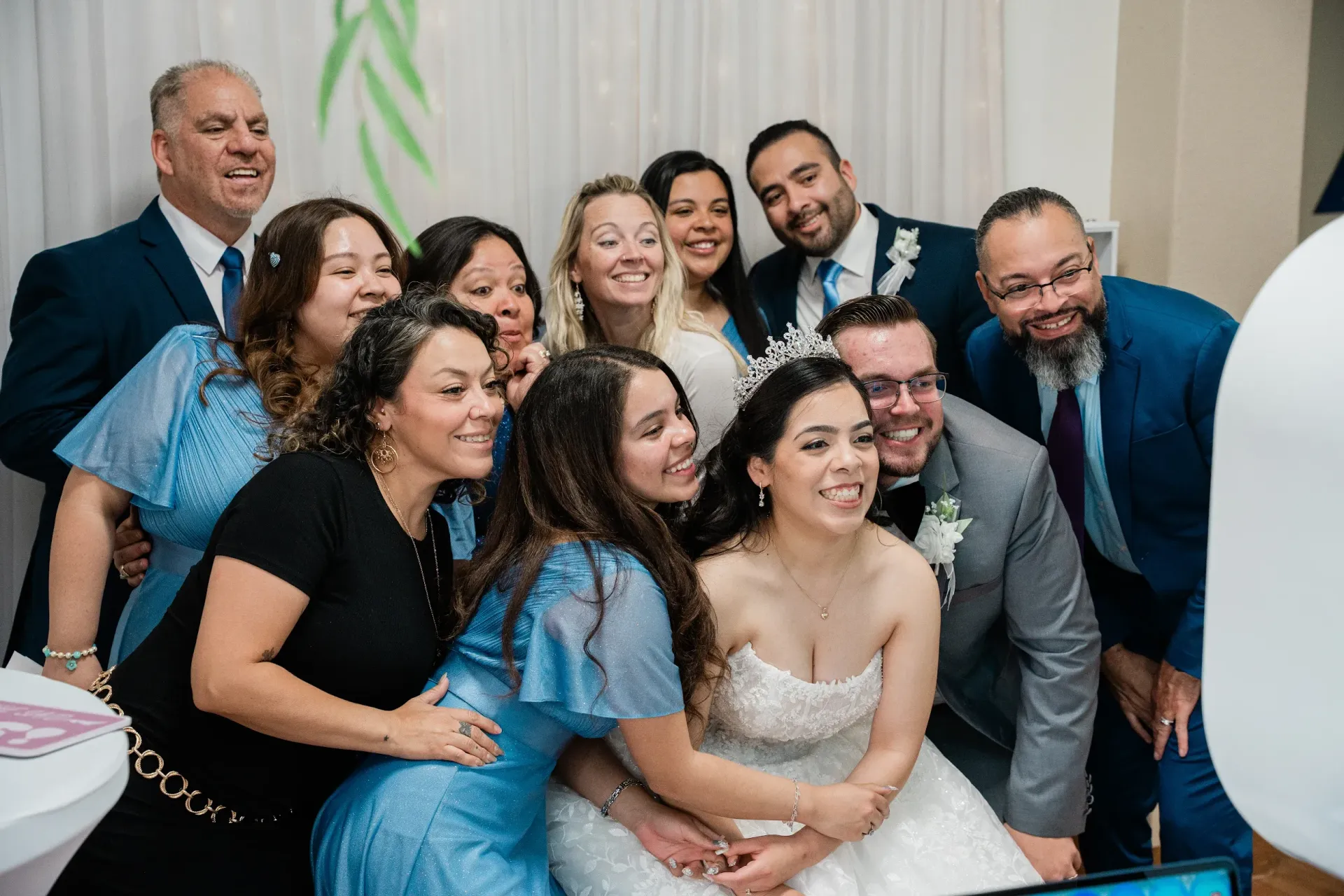 Guests gathered around the Brightlight Photo Booth during a wedding reception at Towngate Community Center in Moreno Valley, CA