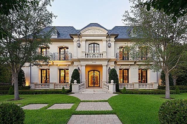 A large white house with a brick walkway leading to it
