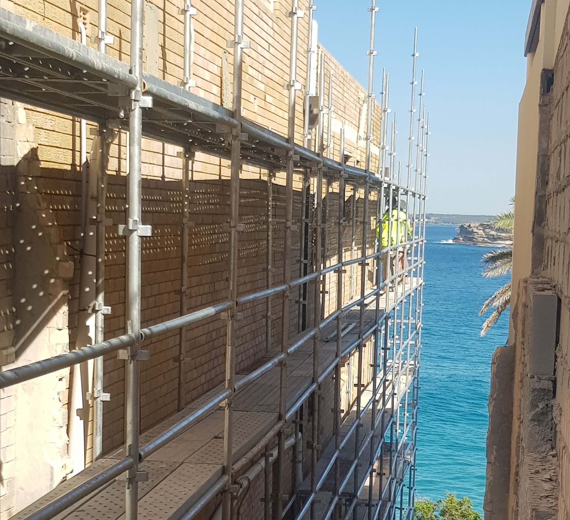 Scaffolding installed on uneven ground for a commercial apartment restoration in Sydney