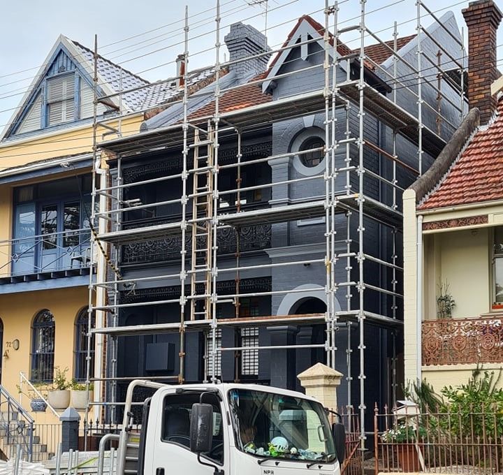 Scaffolding installed on a heritage terrace for home renovation, ensuring safe access for trades