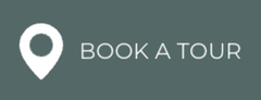 White map pin icon with “BOOK A TOUR” text on a gray background