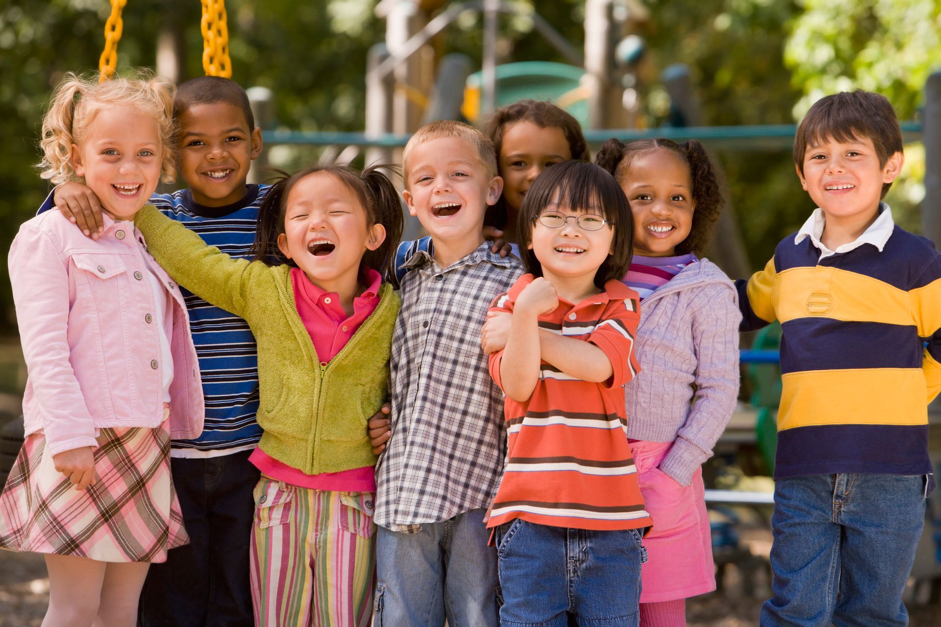 A group of children posing for a picture at a playground